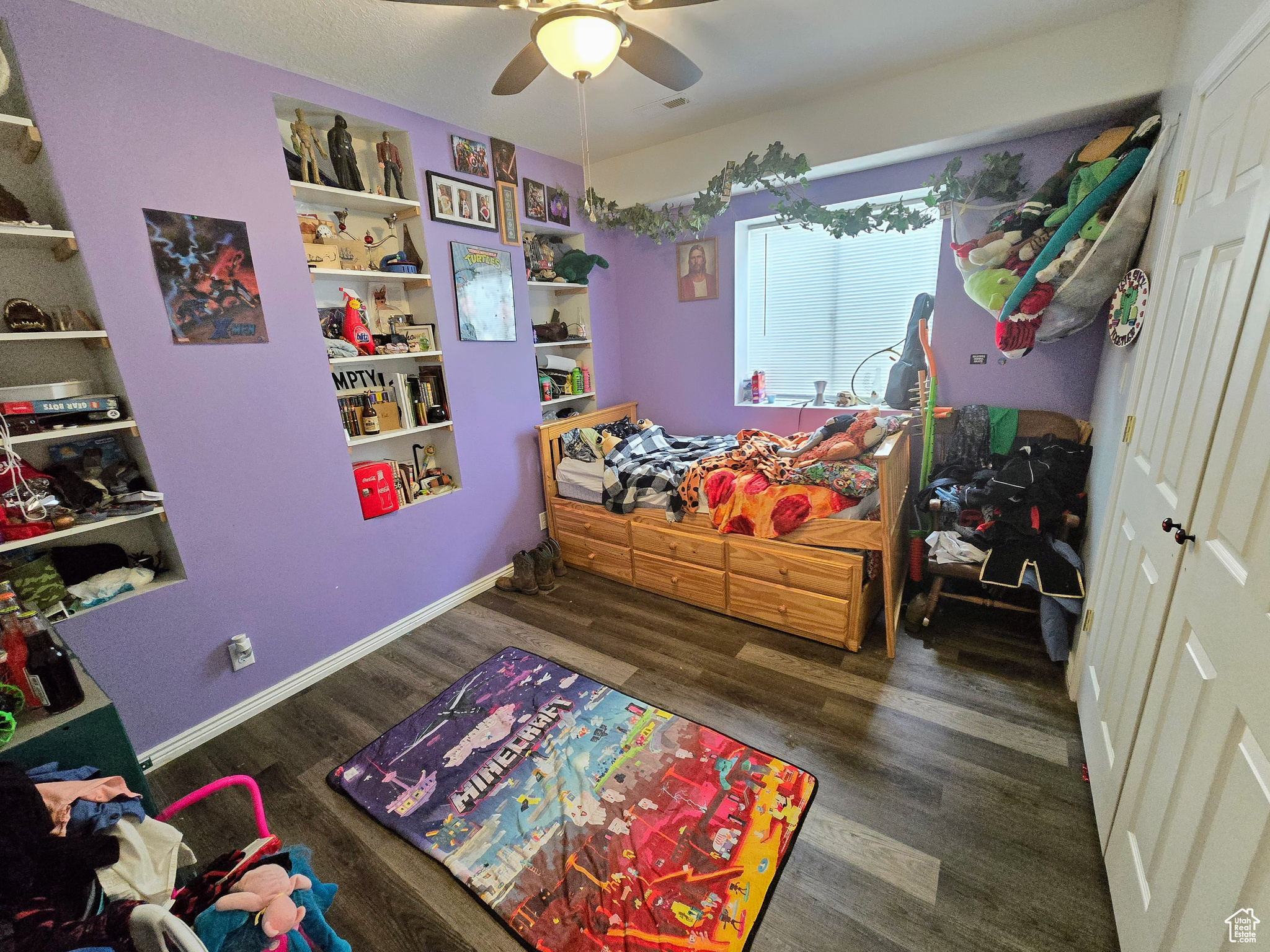 Bedroom with dark hardwood / wood-style flooring and ceiling fan