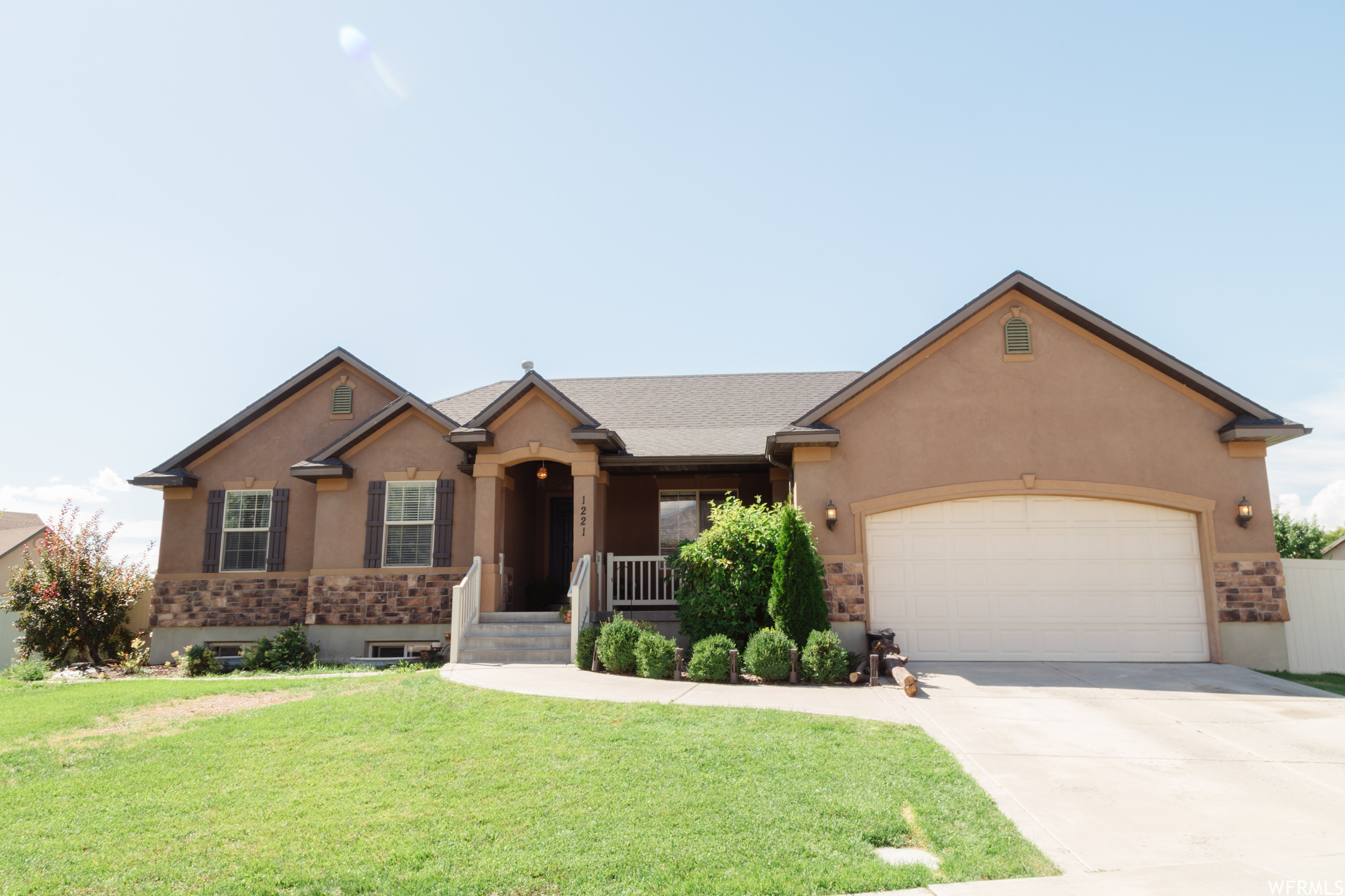 Ranch-style home featuring a front yard and garage