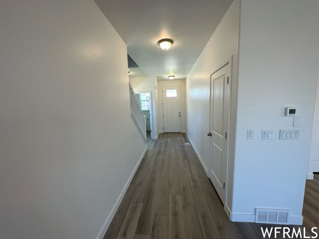 Hallway with dark laminate flooring