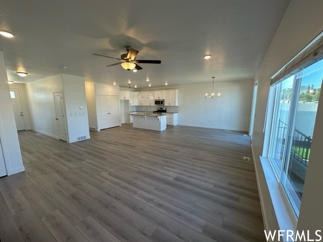 Living room with light laminate flooring and ceiling fan