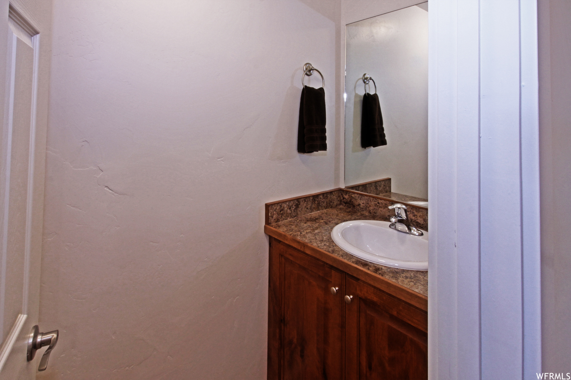 Bathroom featuring large vanity and mirror