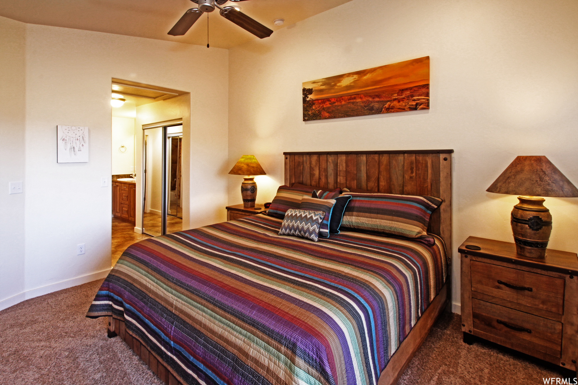 Carpeted bedroom featuring ceiling fan