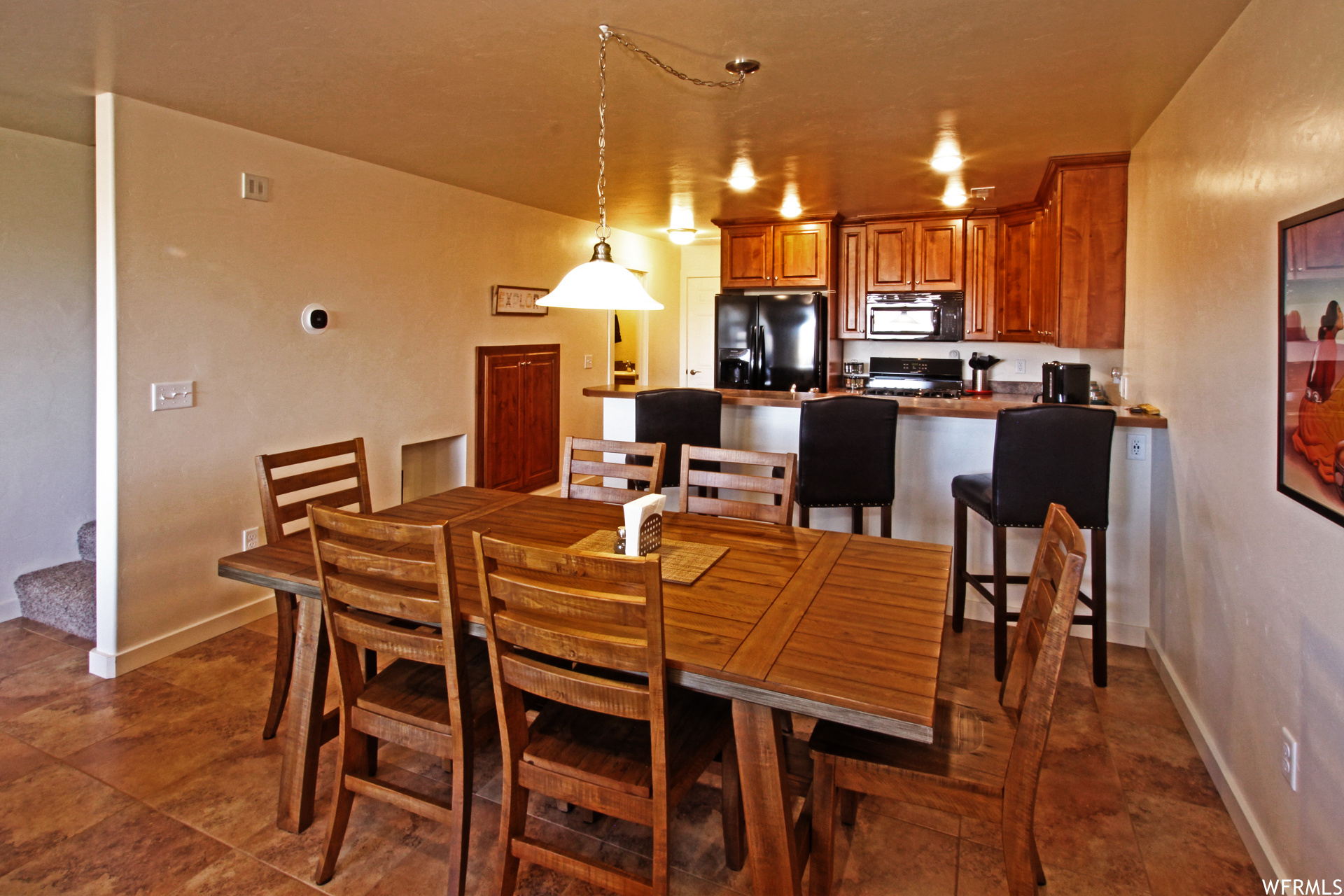 Dining space with dark tile flooring