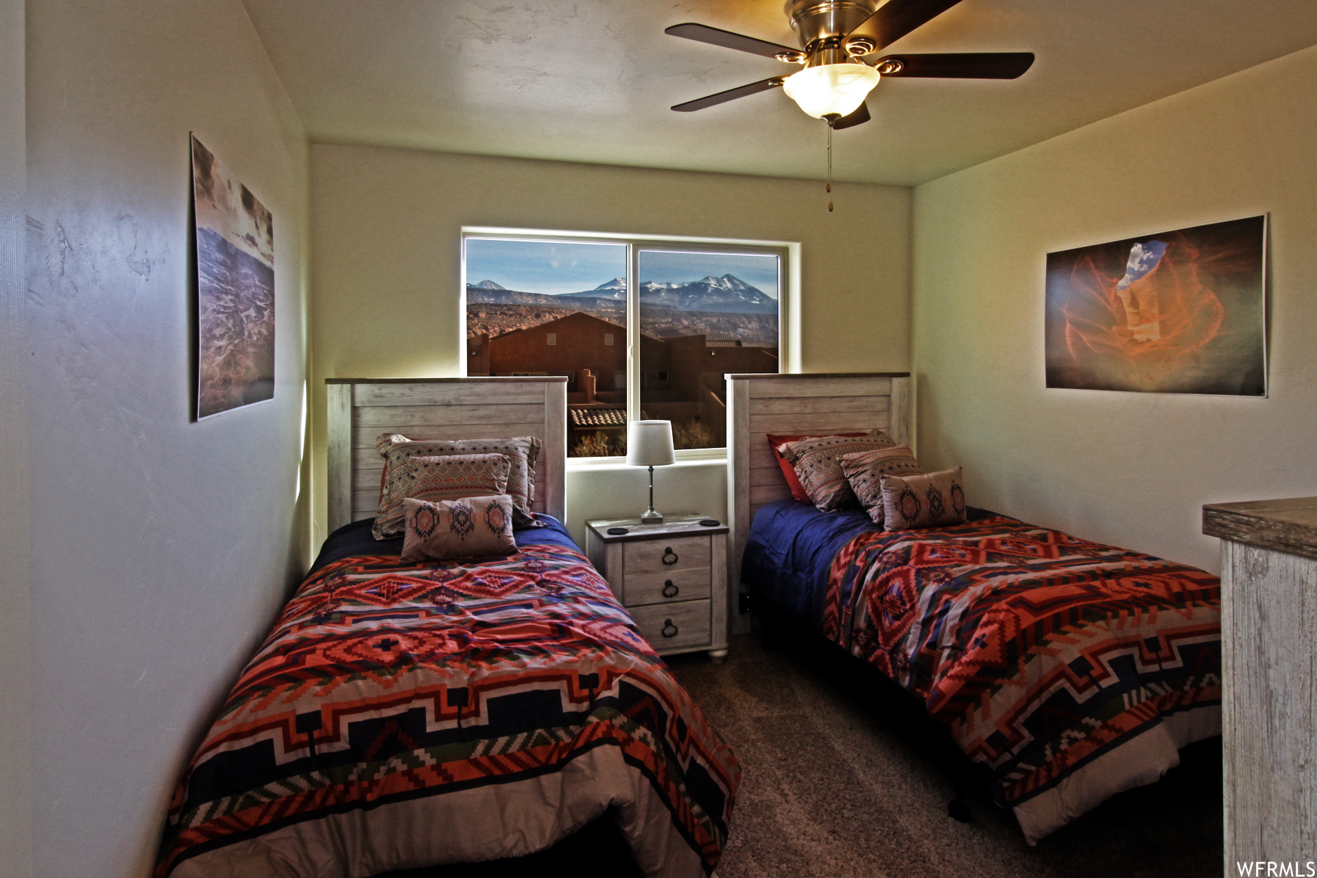 Bedroom with dark carpet and ceiling fan