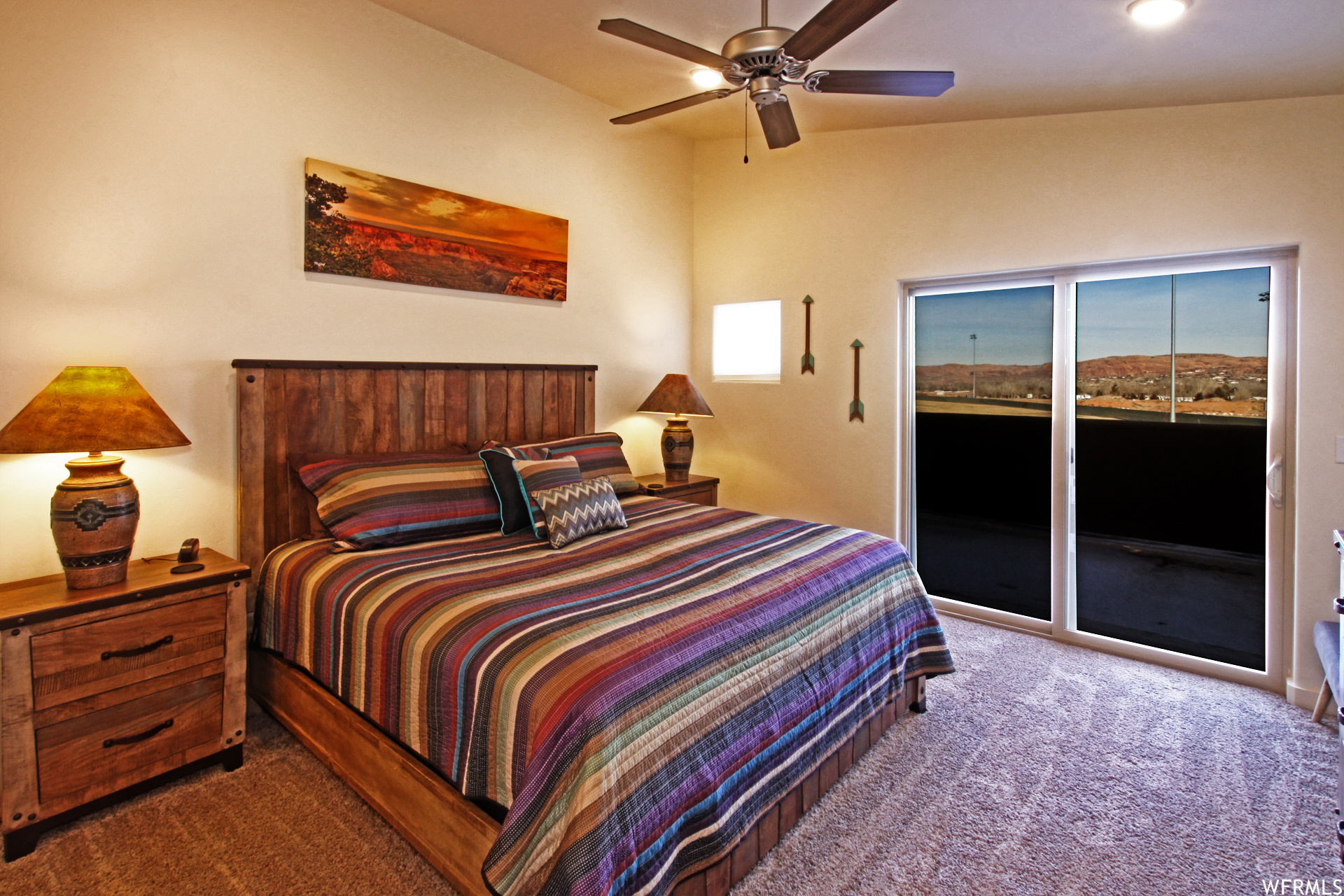 Carpeted bedroom with ceiling fan