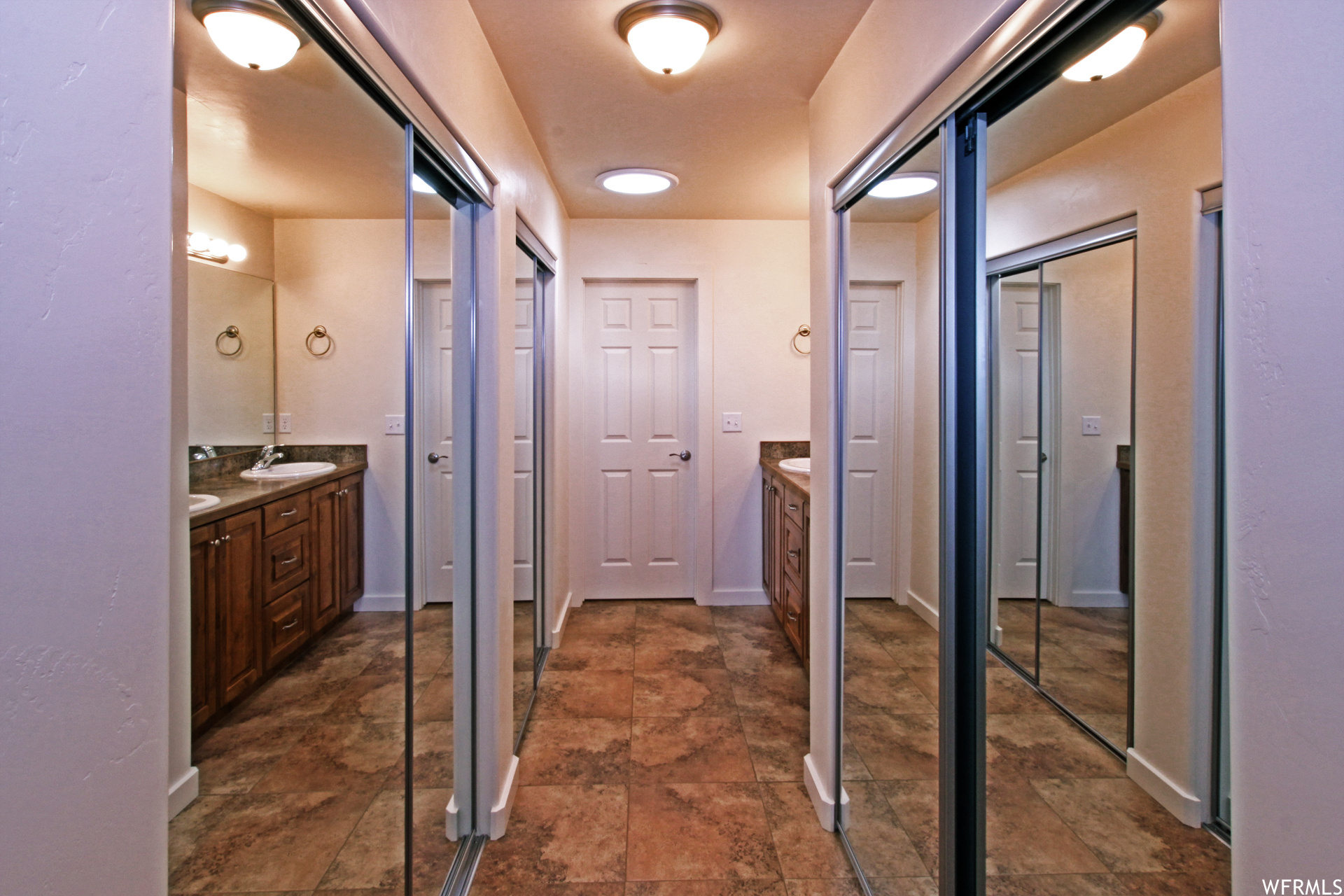 Hall with dark tile flooring