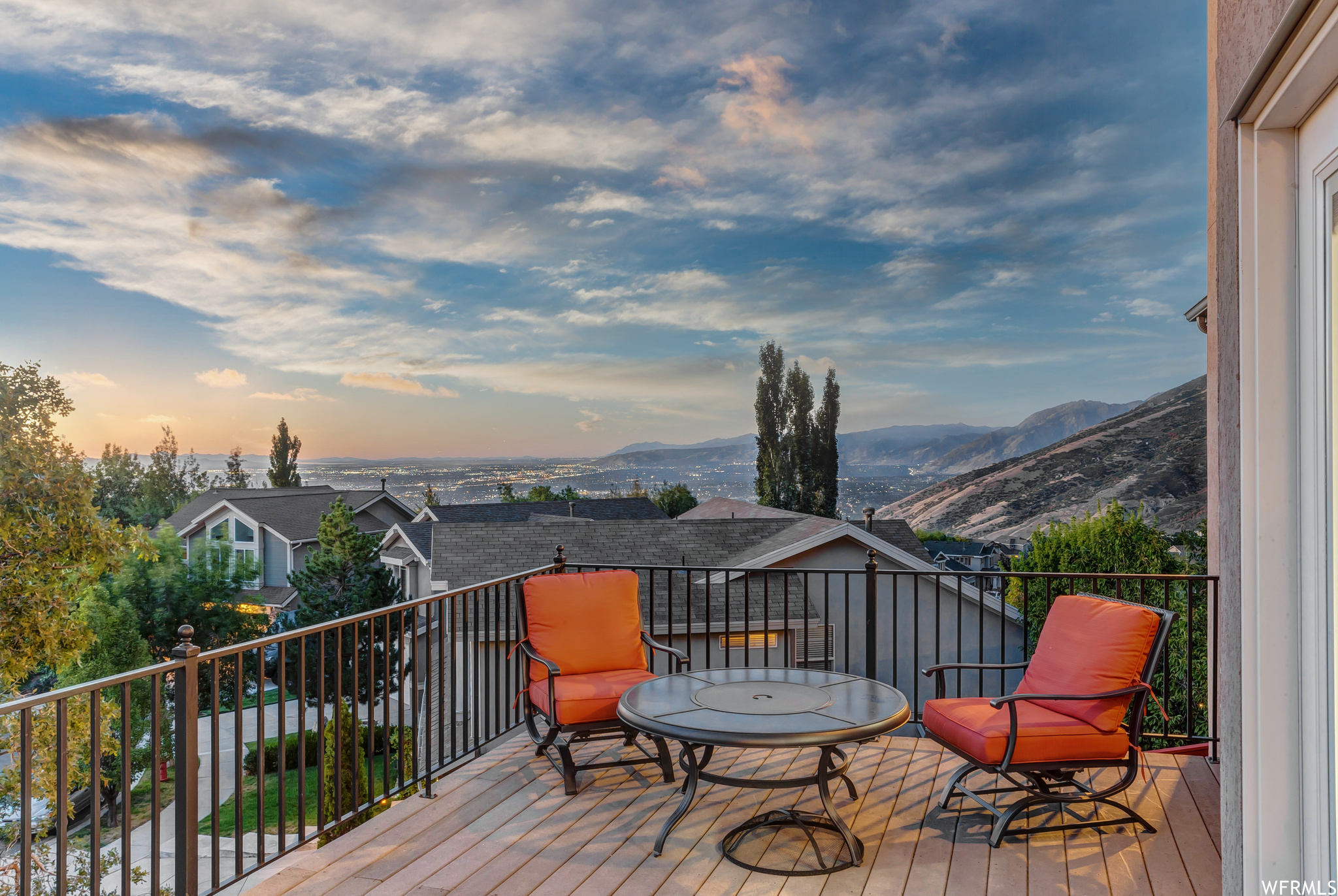 Deck at dusk featuring valley and mountain view