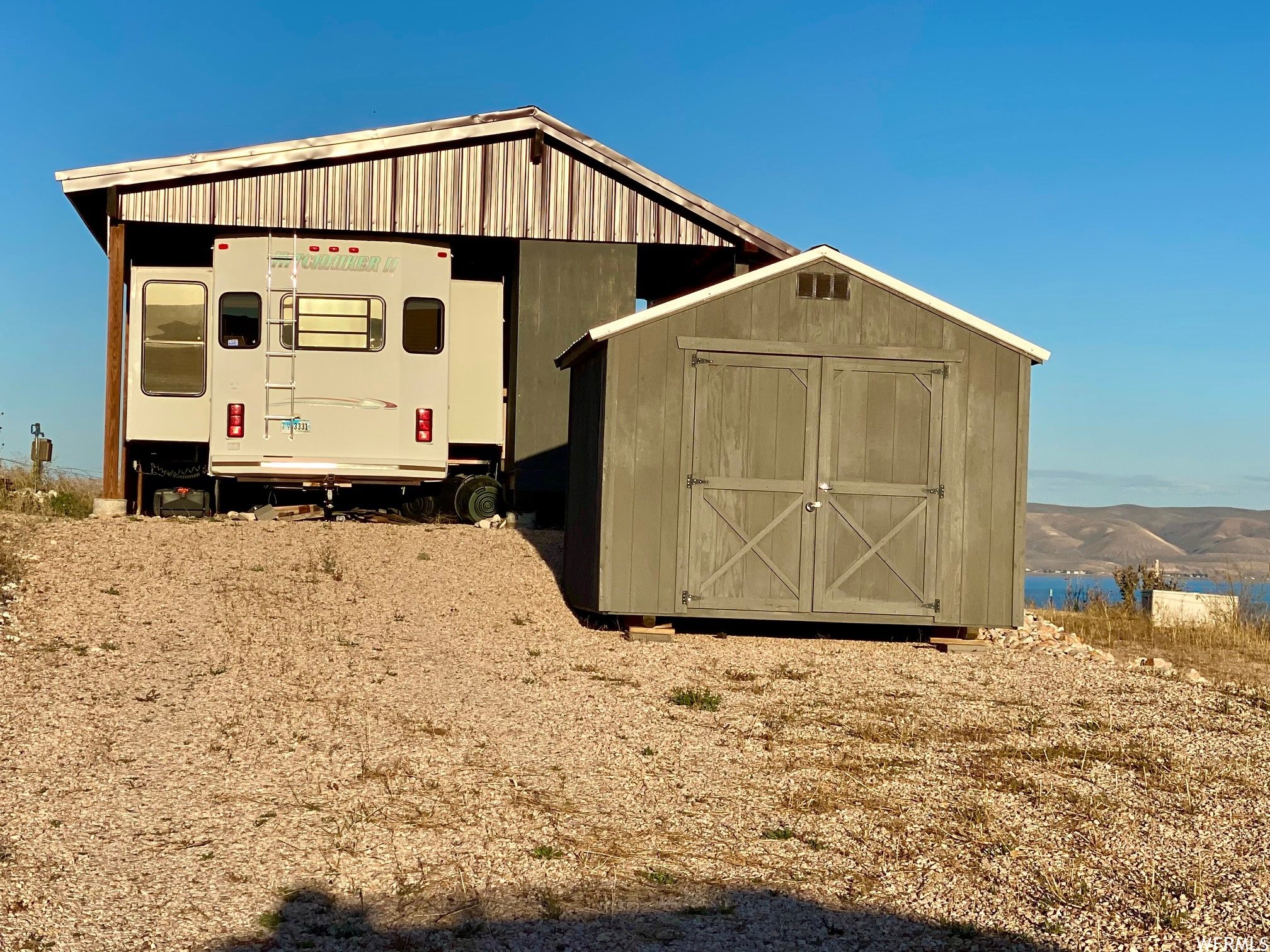 Covered RV with deck and shed