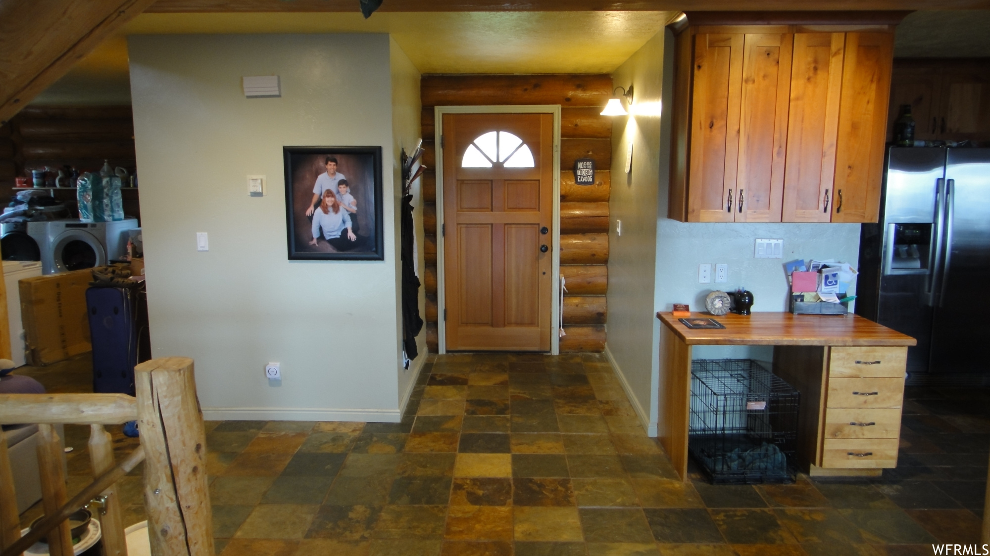 Tiled entryway with rustic walls.