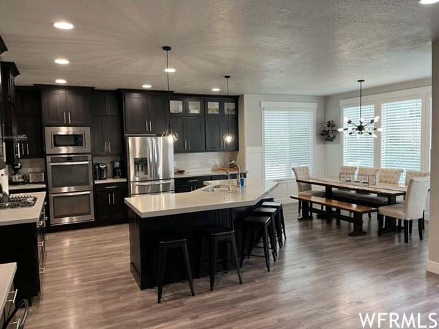 Custom gourmet kitchen, butterfly island, solid wood cabinets, gray quartz countertops & double oven.