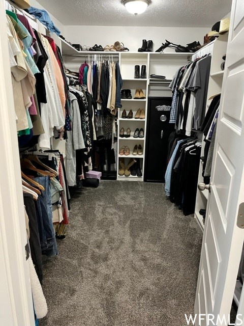Walk in closet with built-in cubbies.