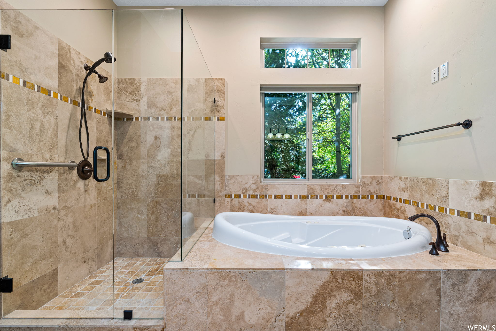 Bathroom featuring shower with separate bathtub