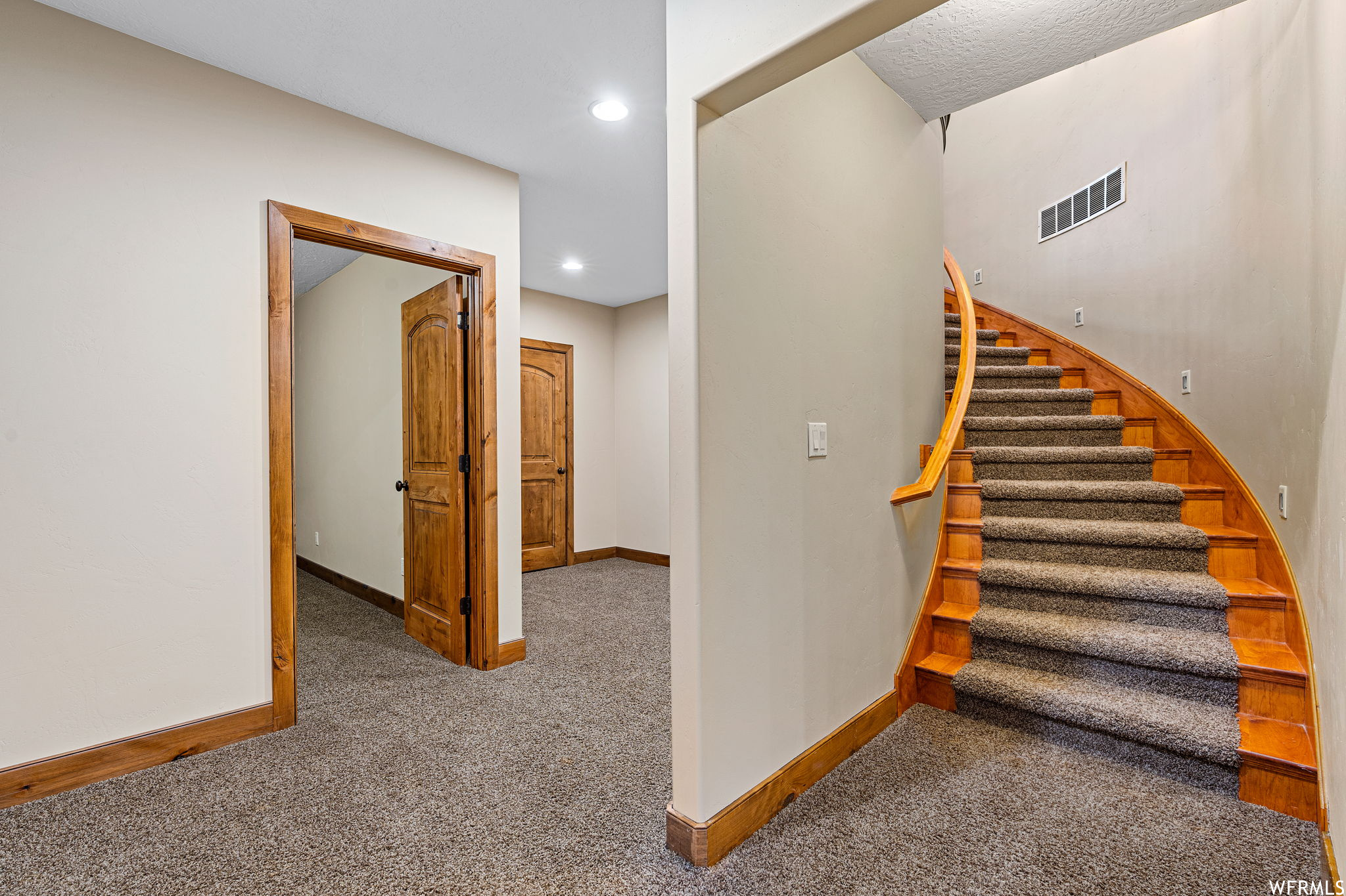 Stairs with light colored carpet