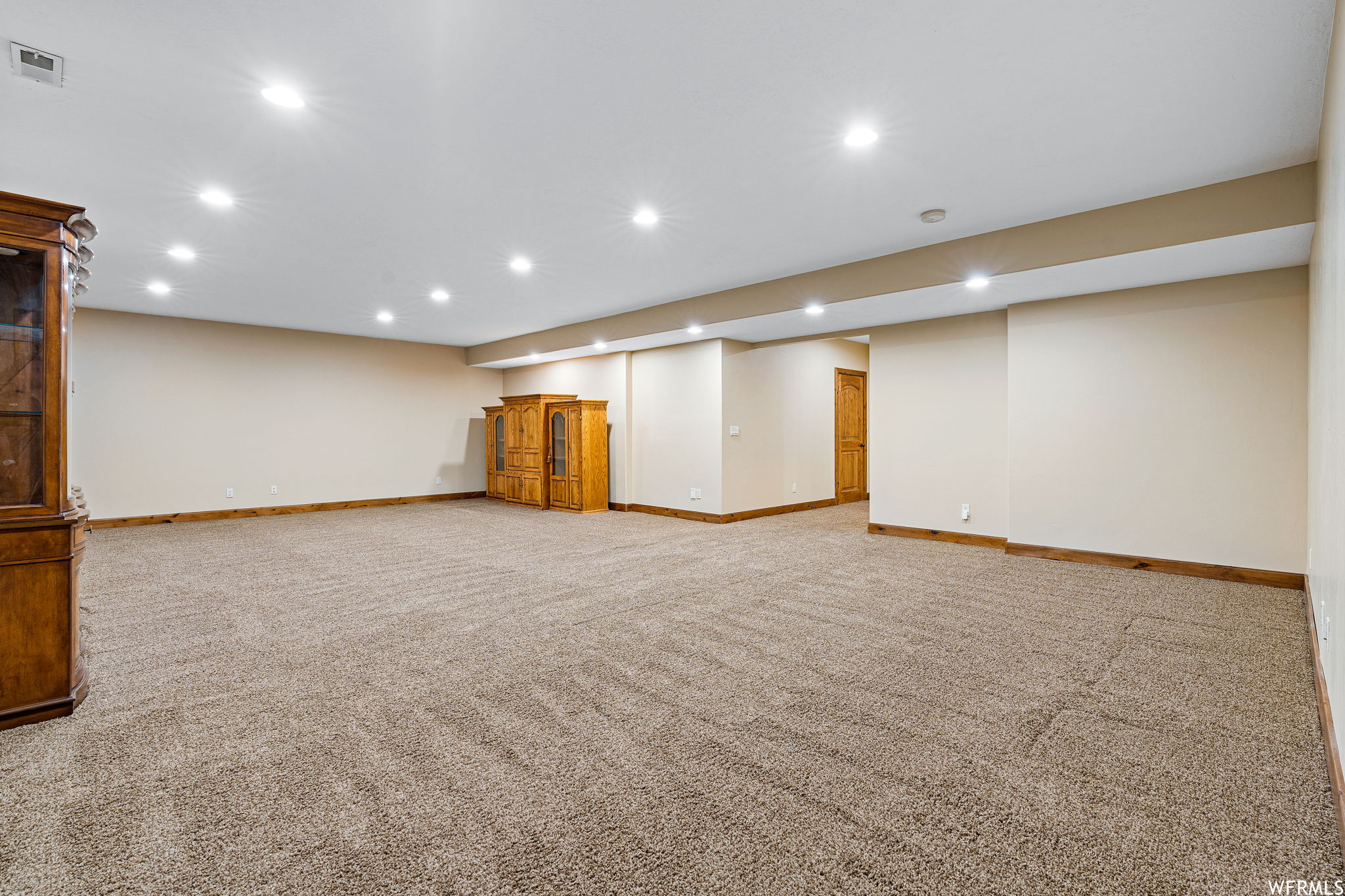 Basement featuring light carpet