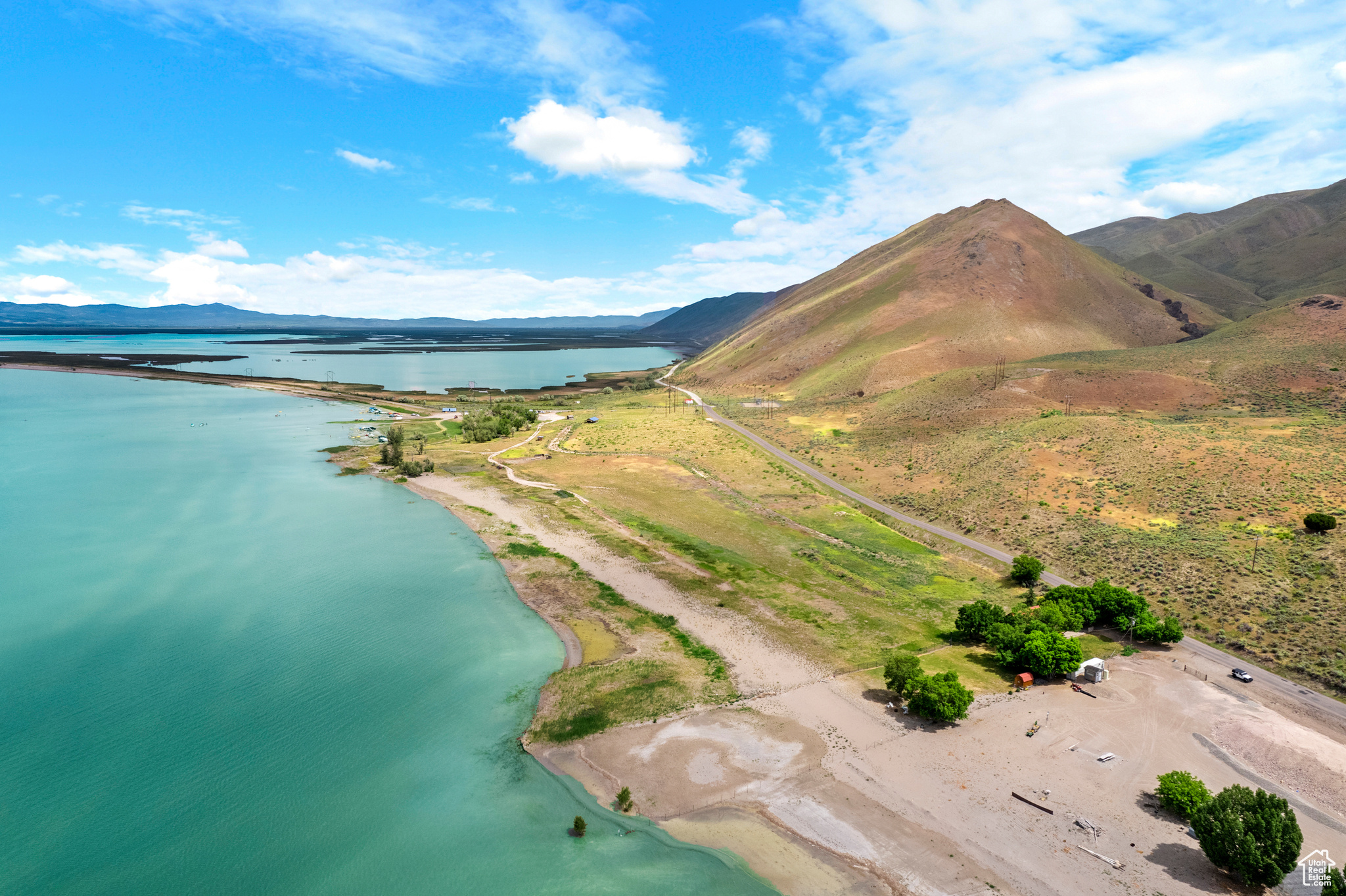 Drone / aerial view featuring a water and mountain view