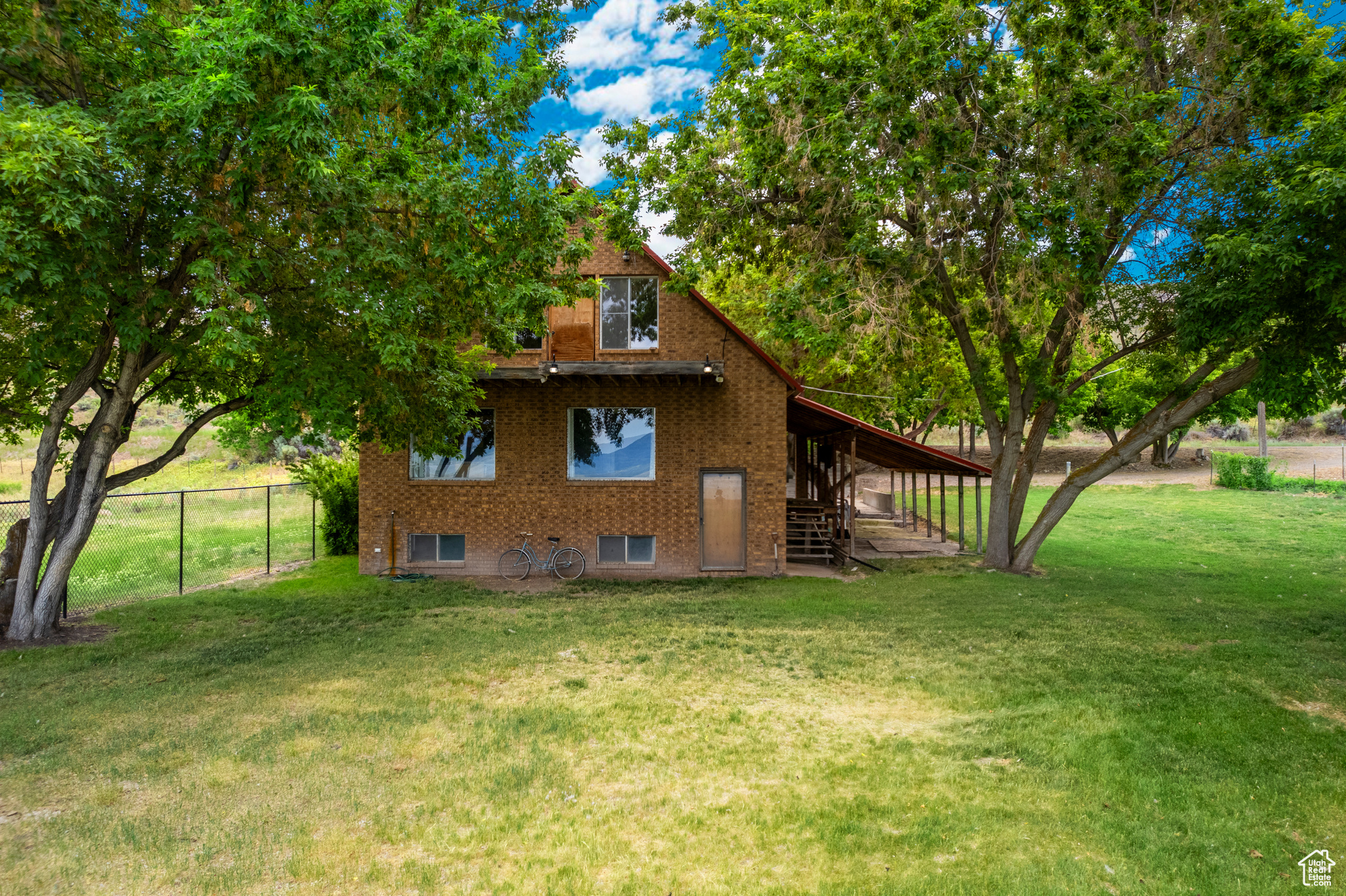 View of property exterior featuring a lawn