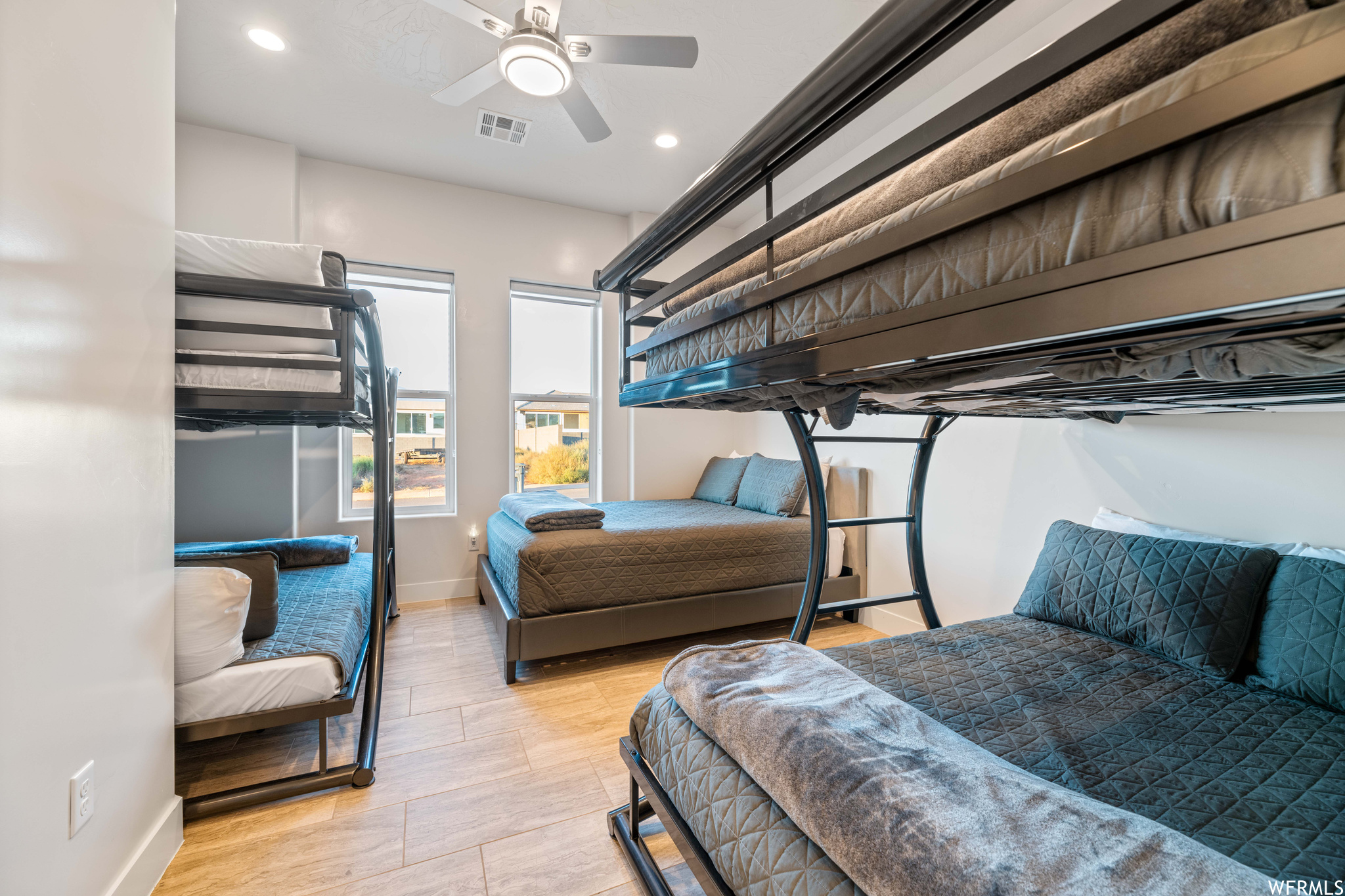 Bedroom with ceiling fan and light hardwood / wood-style flooring