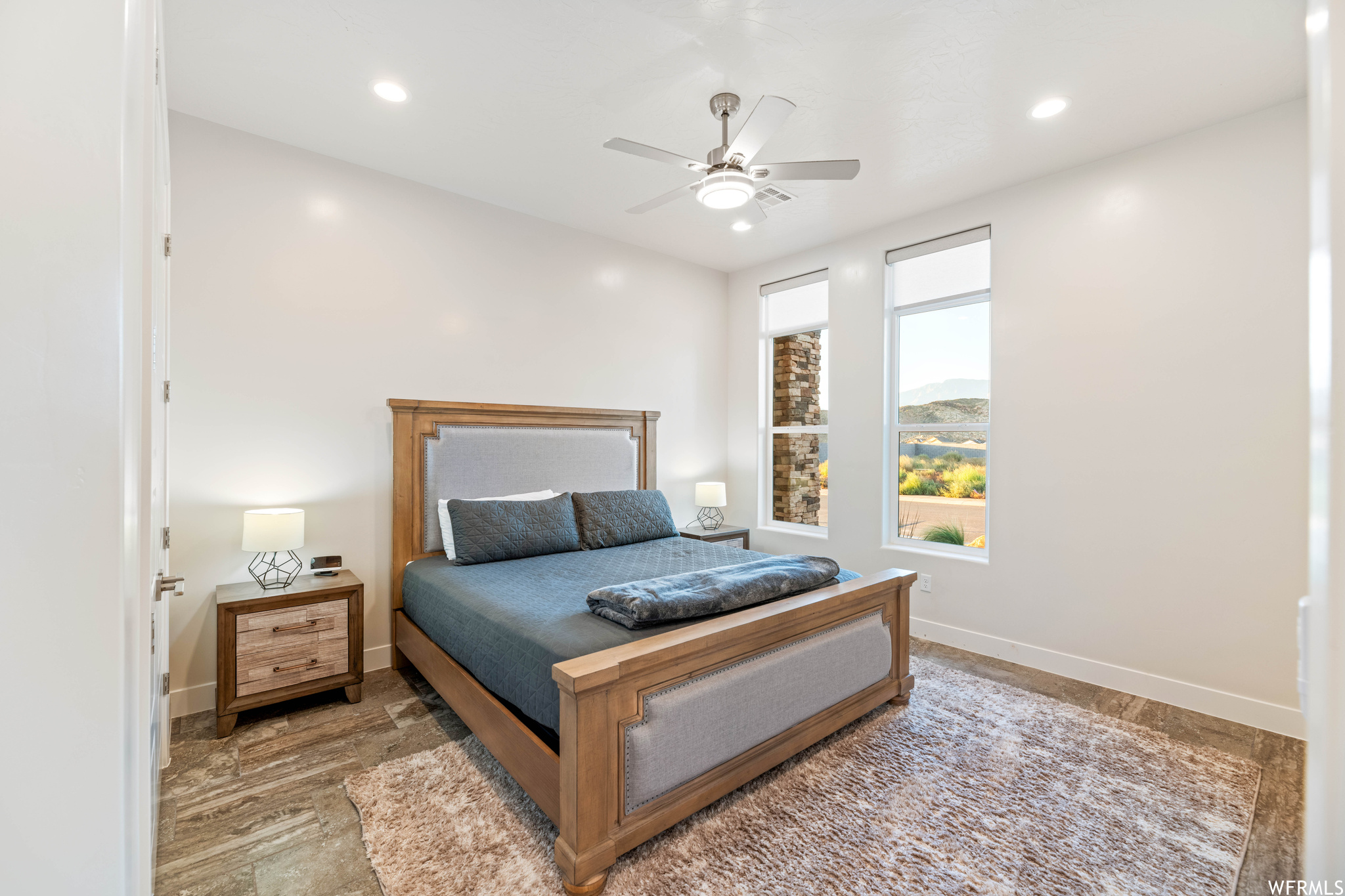 Bedroom featuring ceiling fan and light hardwood / wood-style flooring