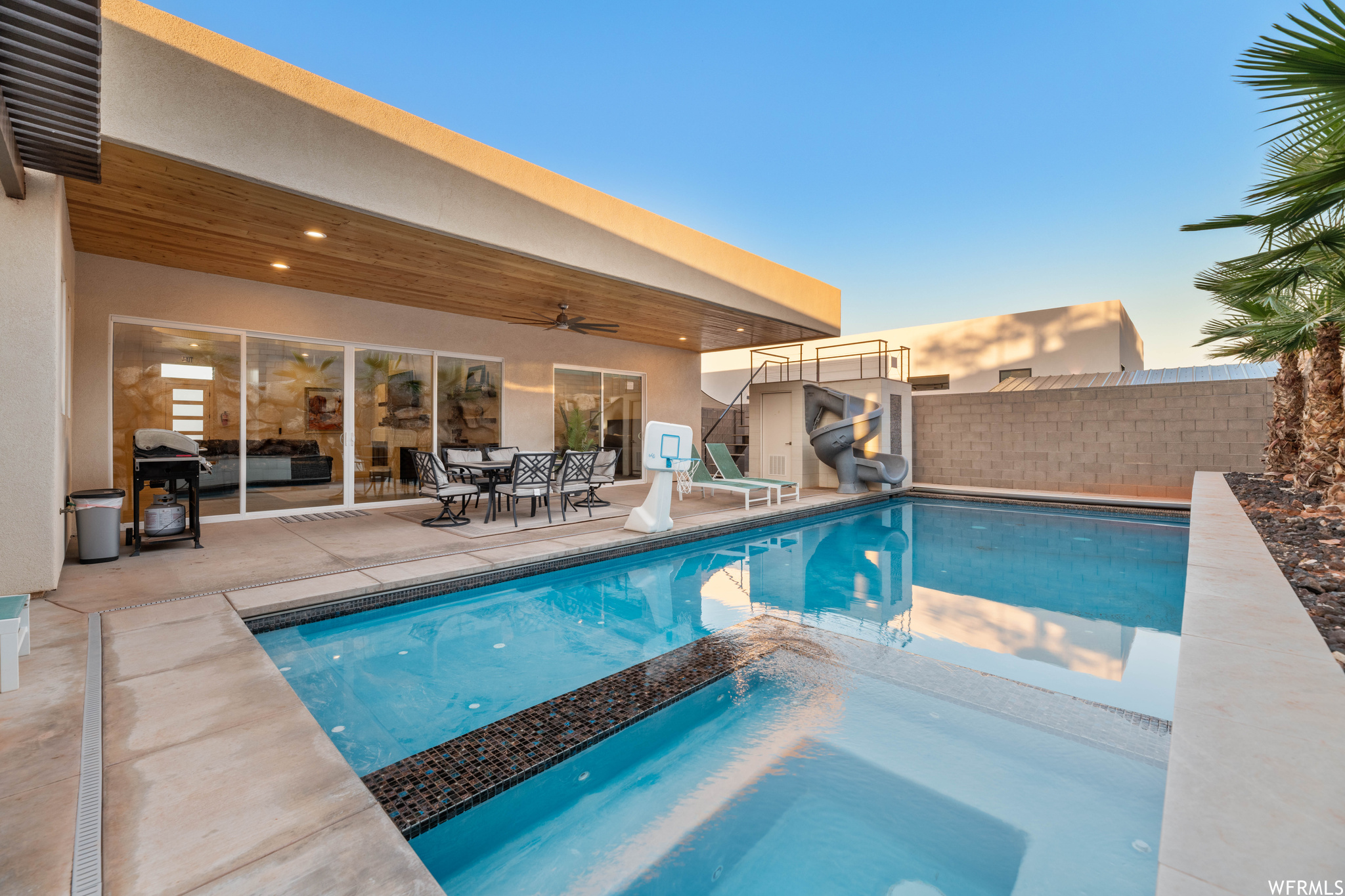 Pool at dusk with a patio