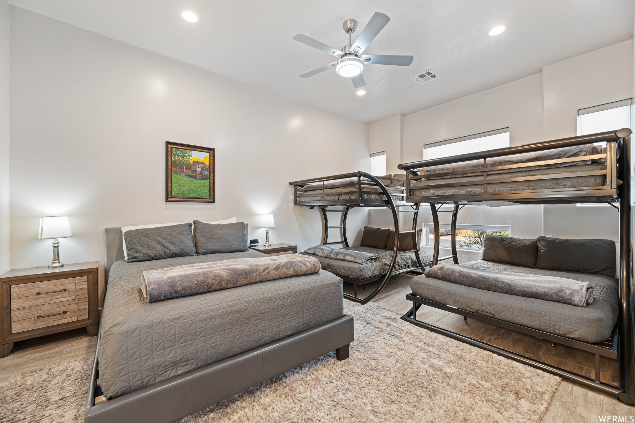 Bedroom with ceiling fan and light wood-type flooring