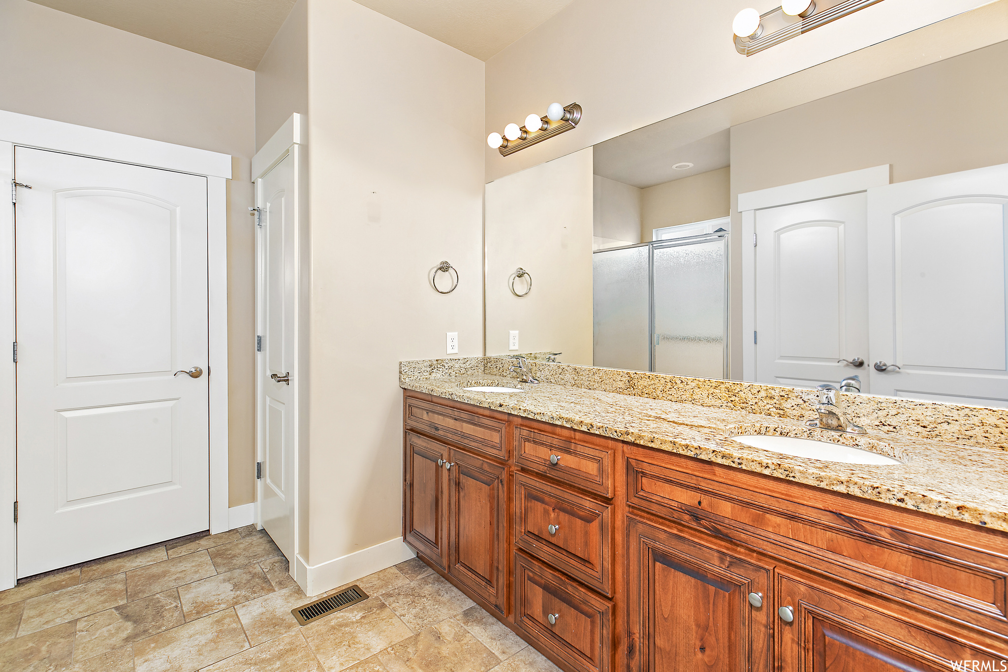 Master Bathroom with double vanity and tile flooring