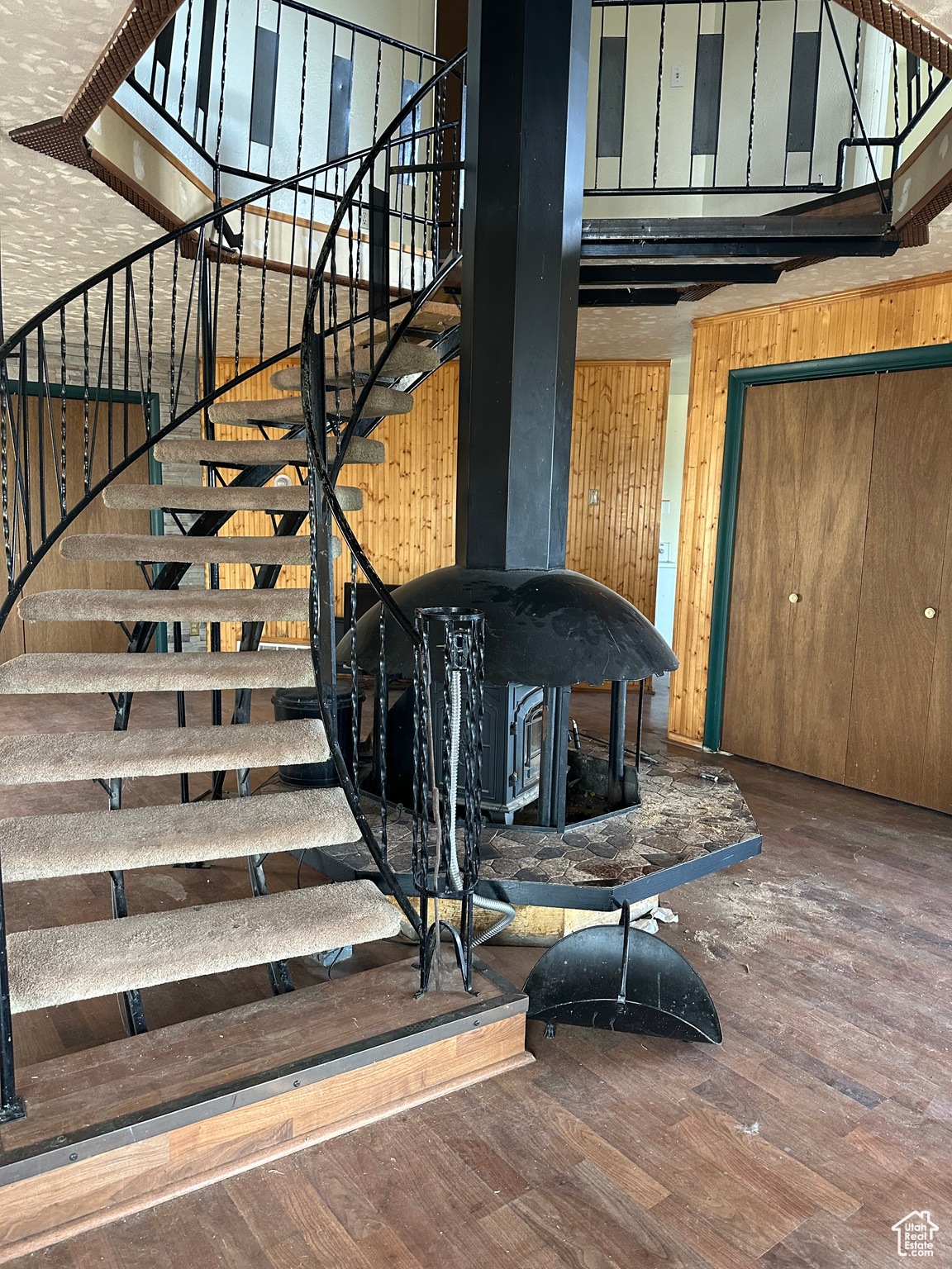 Staircase featuring wood walls and hardwood / wood-style floors