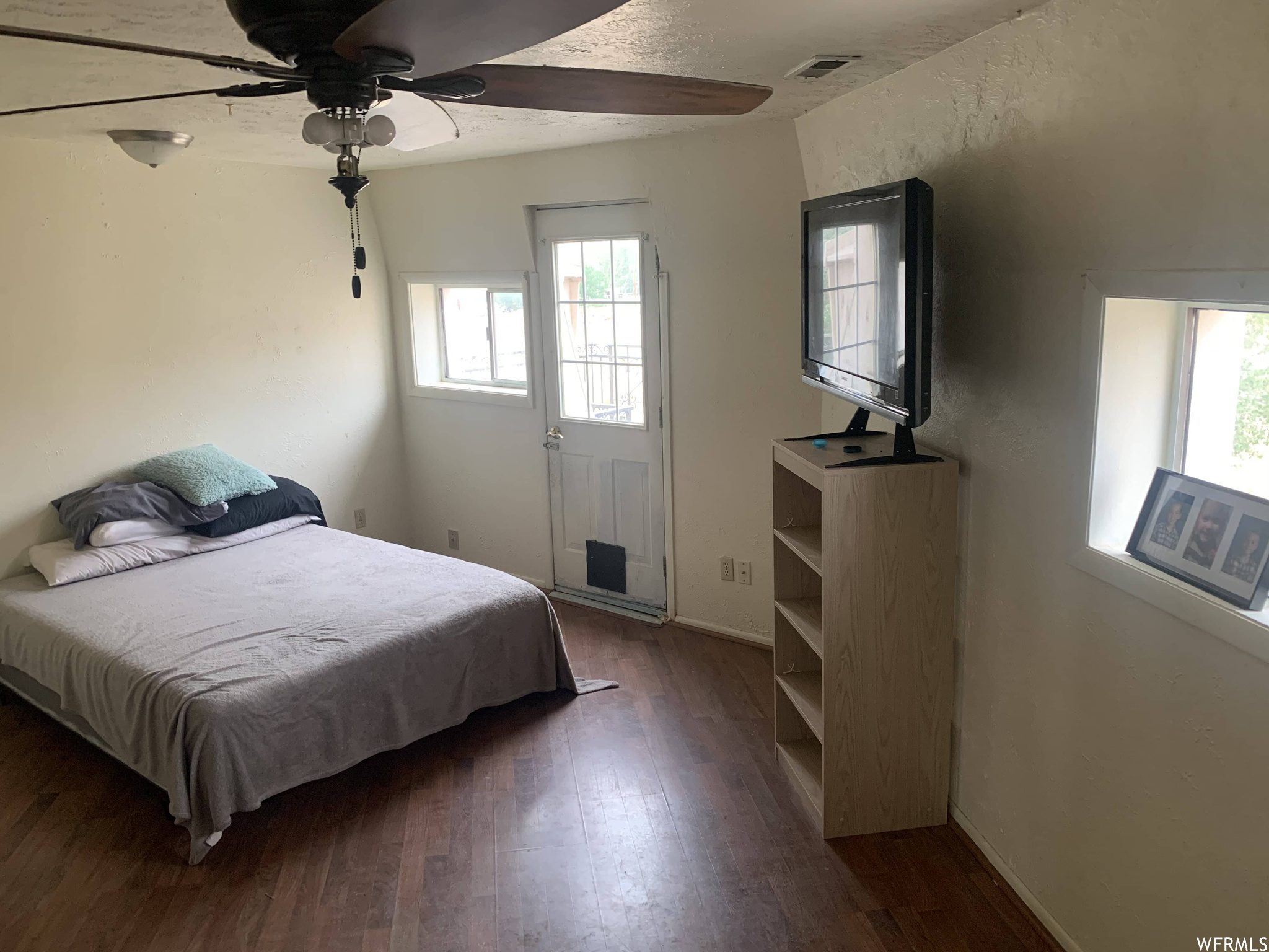 Bedroom featuring dark hardwood flooring and ceiling fan