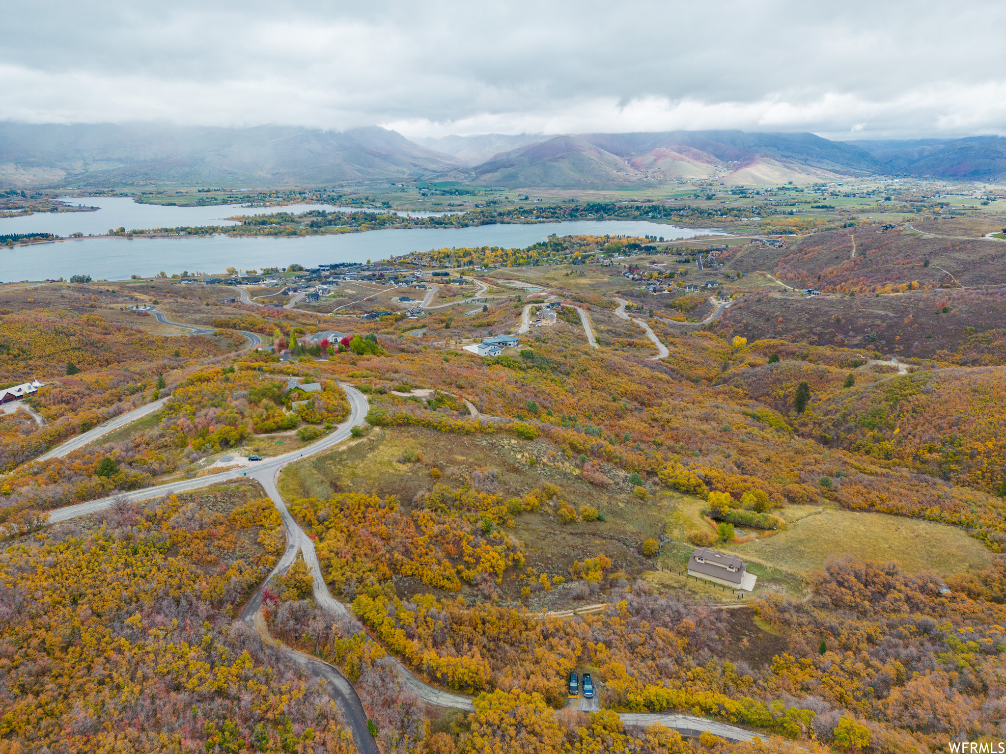 Drone / aerial view featuring a water and mountain view