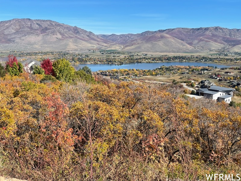 Property view of mountains with a water view