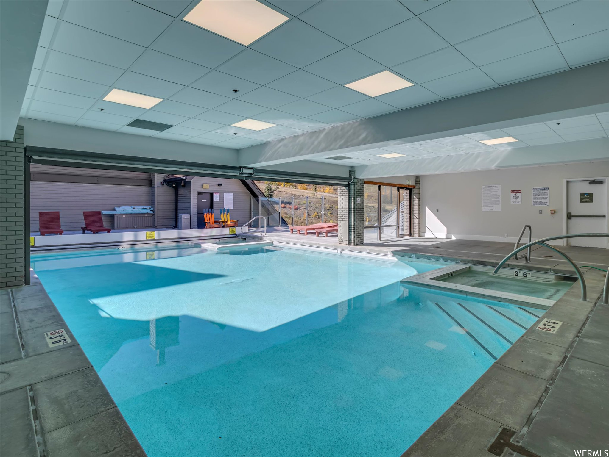 View of pool with an indoor hot tub