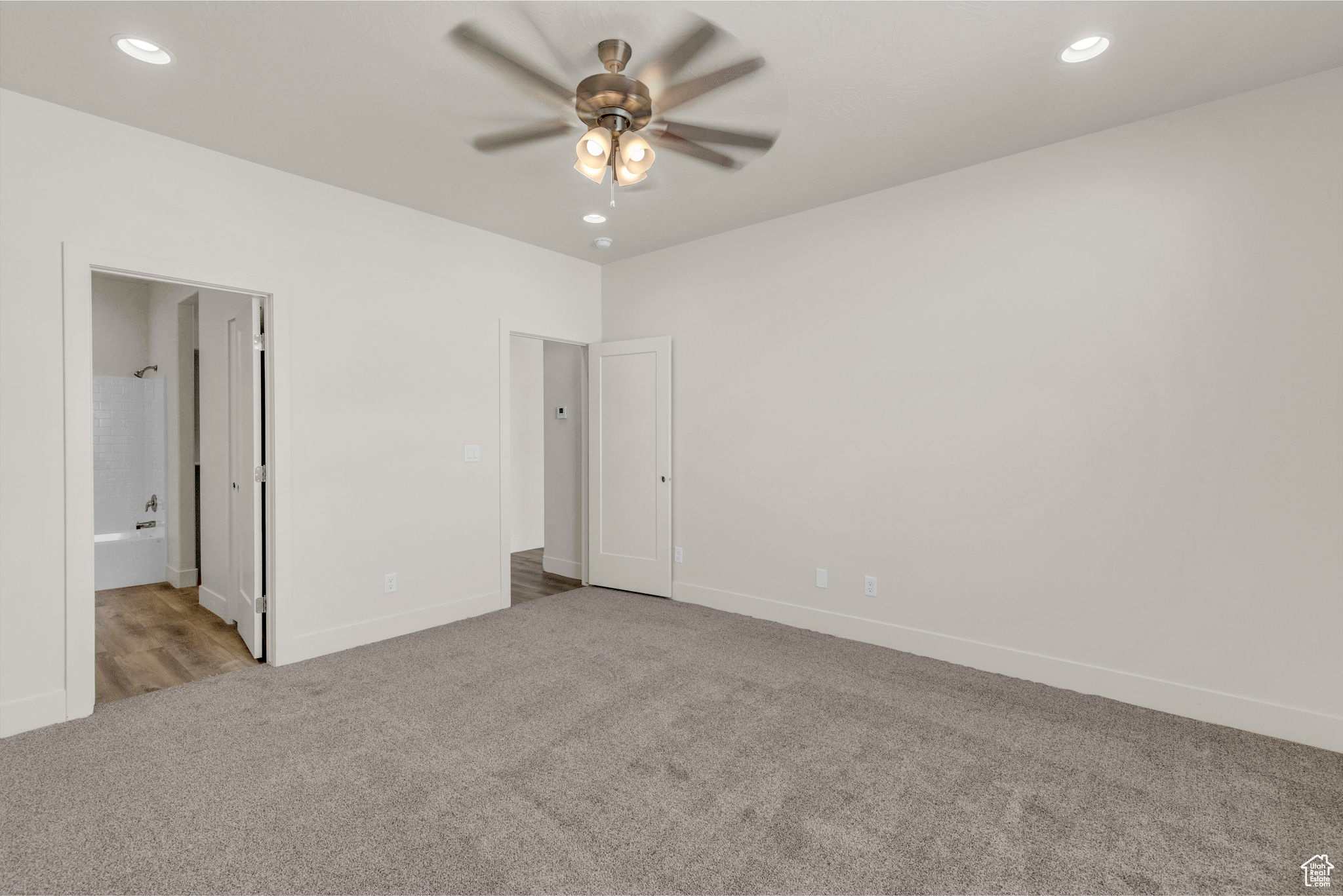 Primary bedroom, Carpeted spare room with ceiling fan