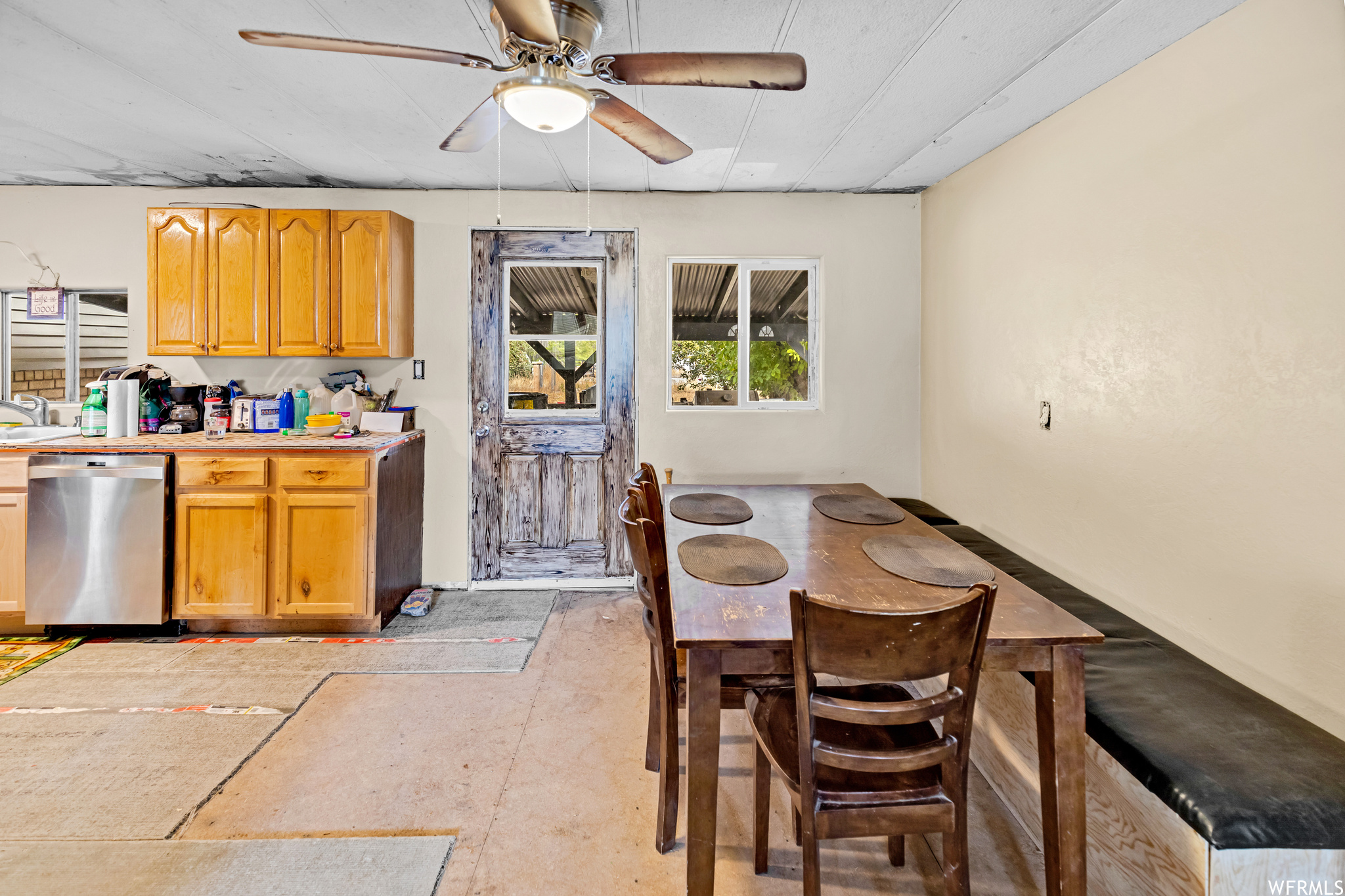 Kitchen featuring stainless steel dishwasher and ceiling fan