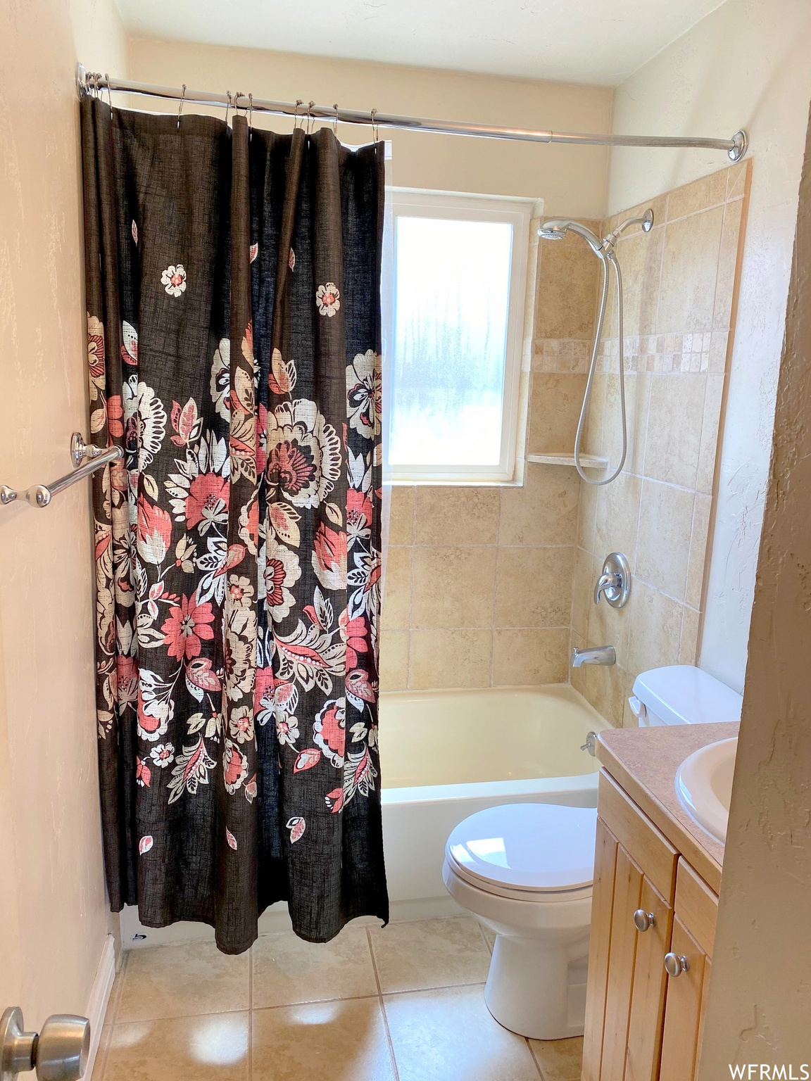 Full bathroom with vanity, tile flooring, shower / tub combo, and toilet