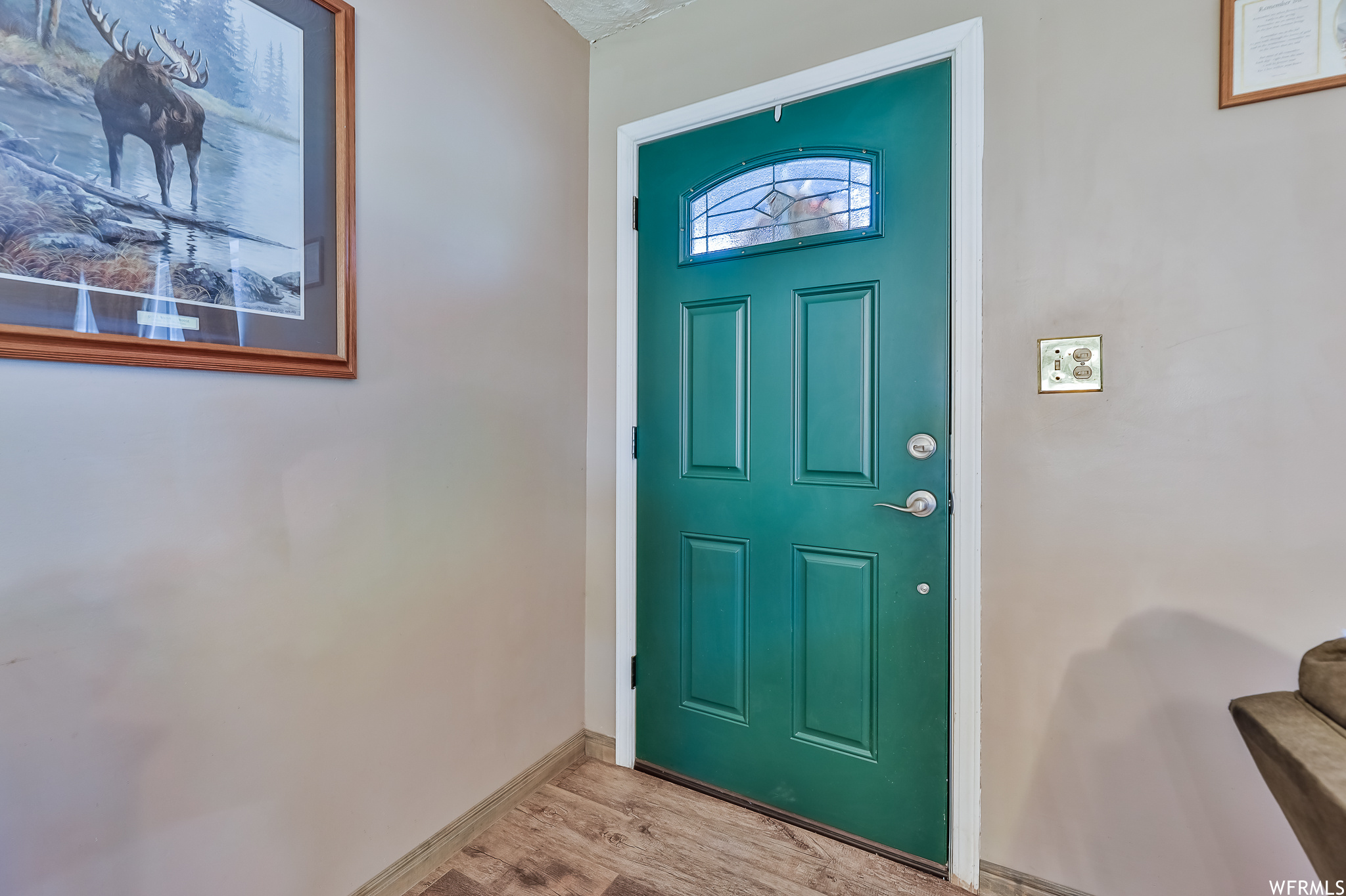 Entrance foyer with light hardwood / wood-style flooring