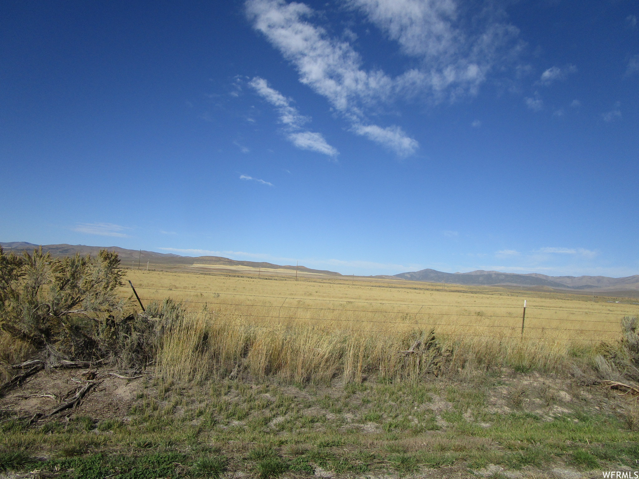 View of local wilderness with a rural view and a mountain view