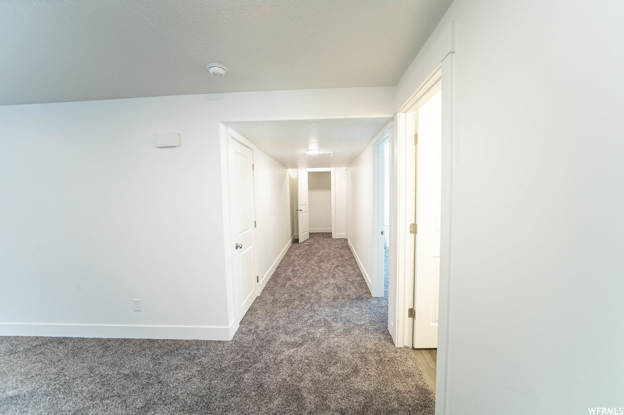 Hallway with carpet floors