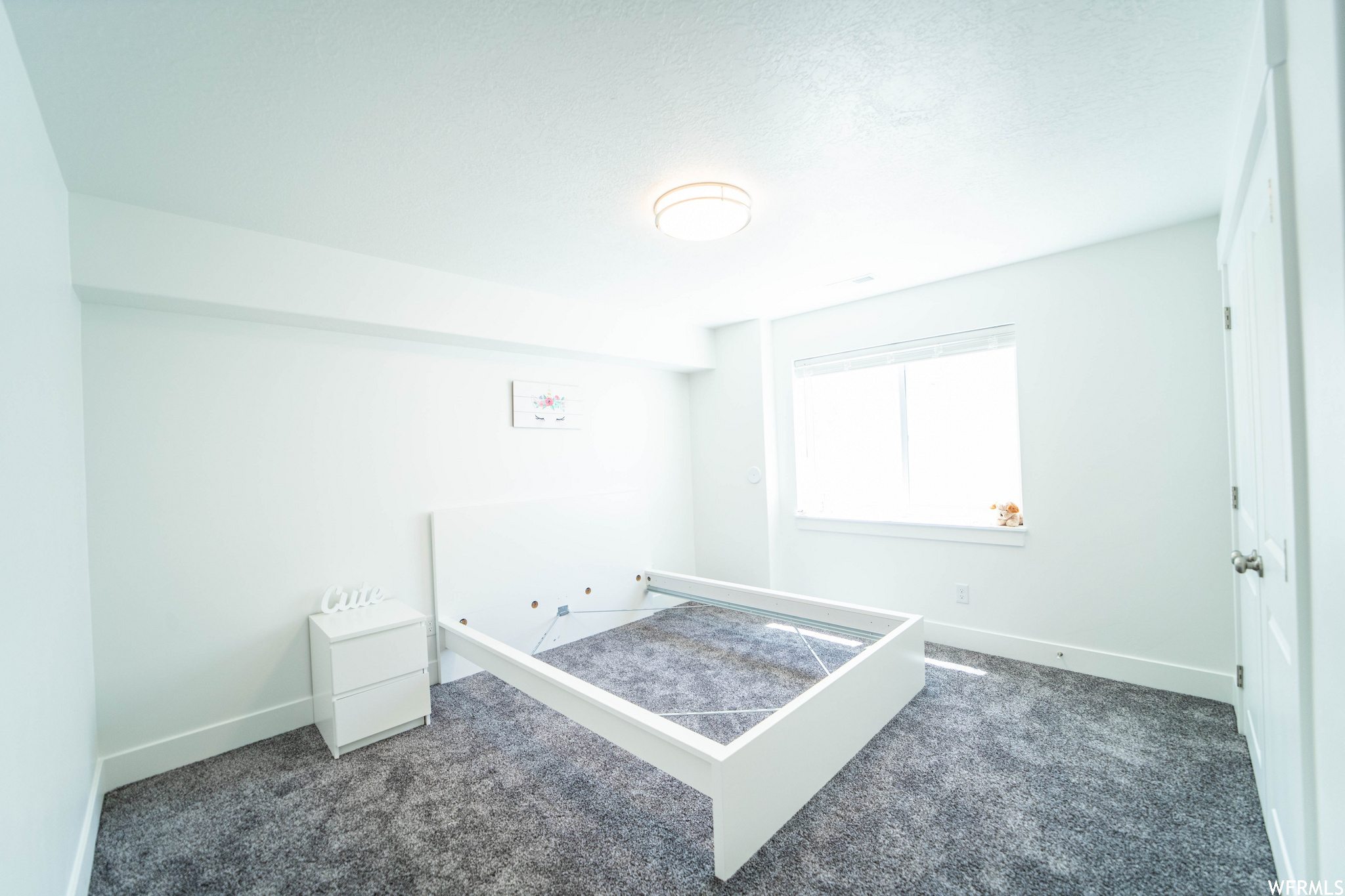 Unfurnished bedroom featuring dark colored carpet