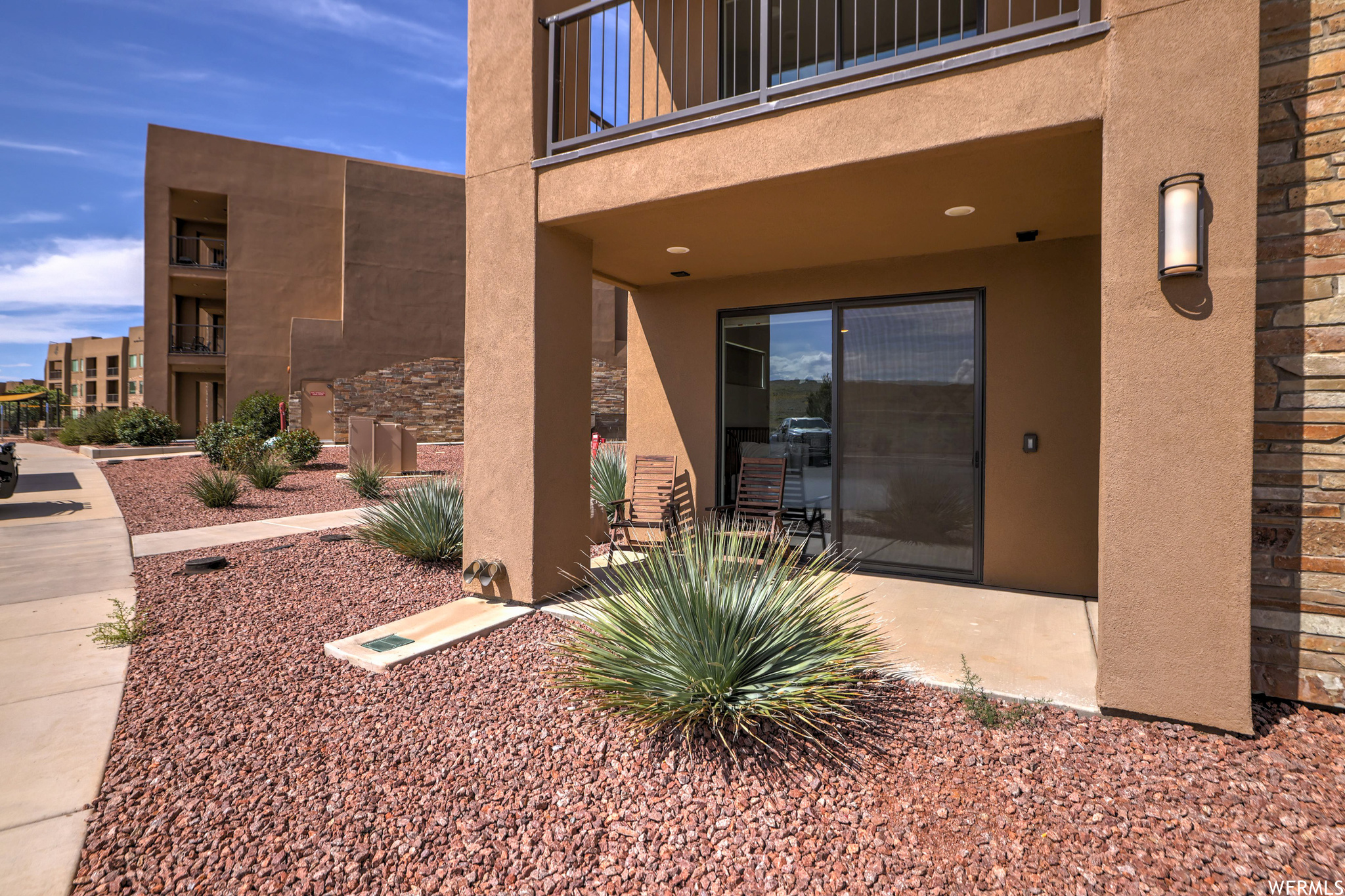 Property entrance with a balcony