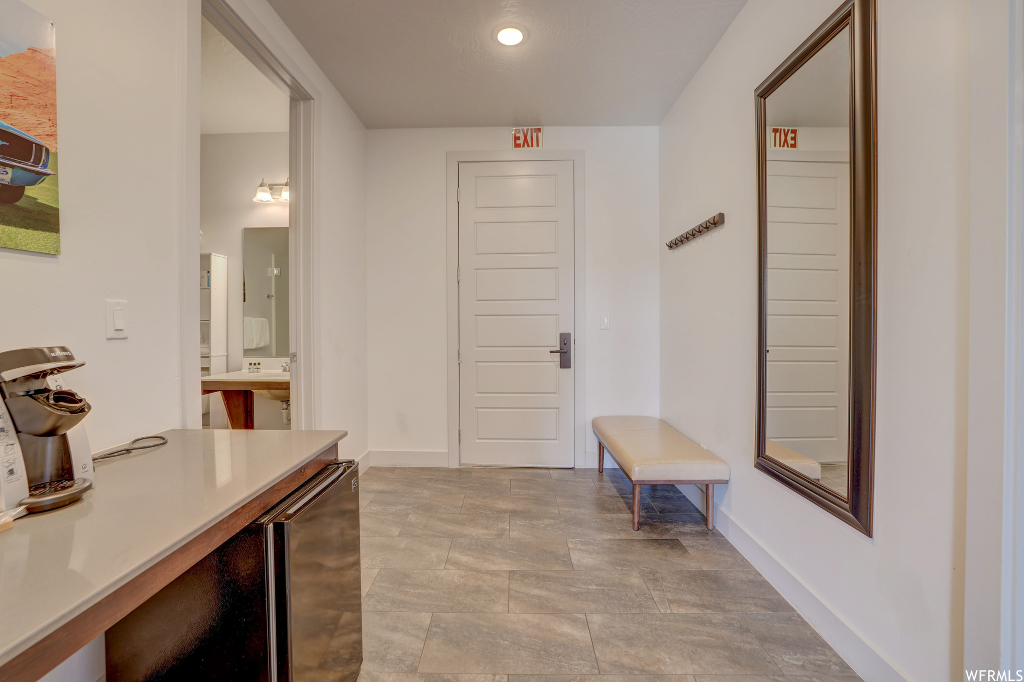 Hallway featuring light tile floors