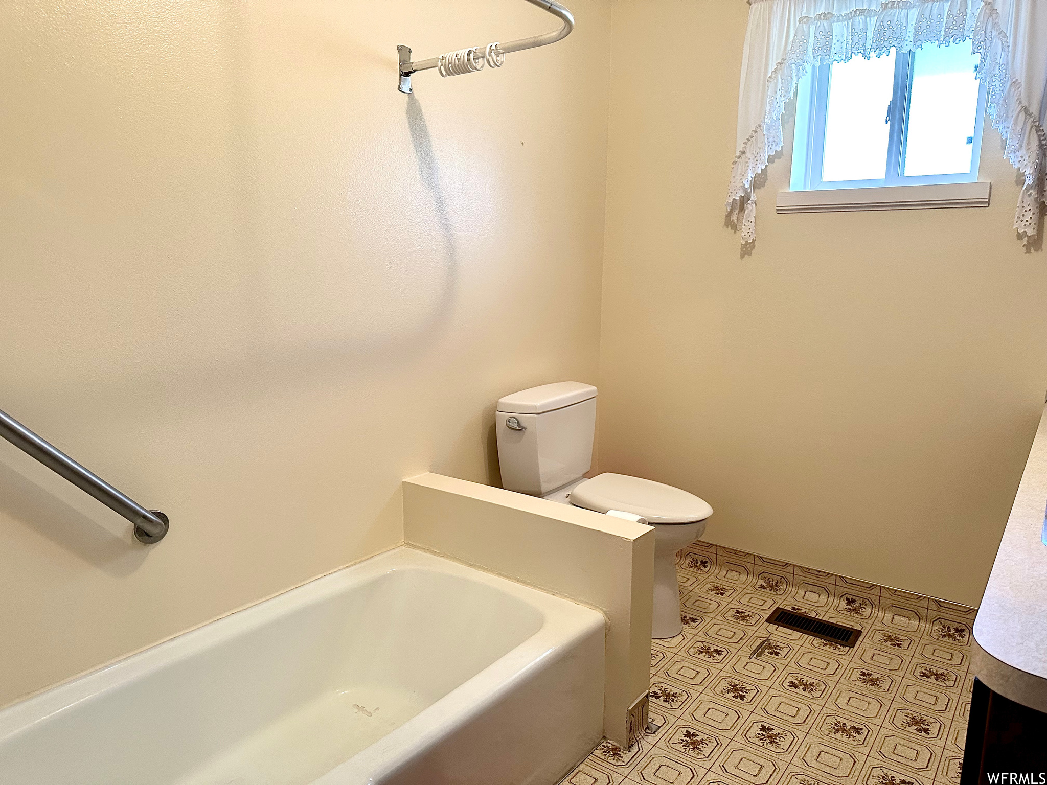 Bathroom with vanity, toilet, and tile floors