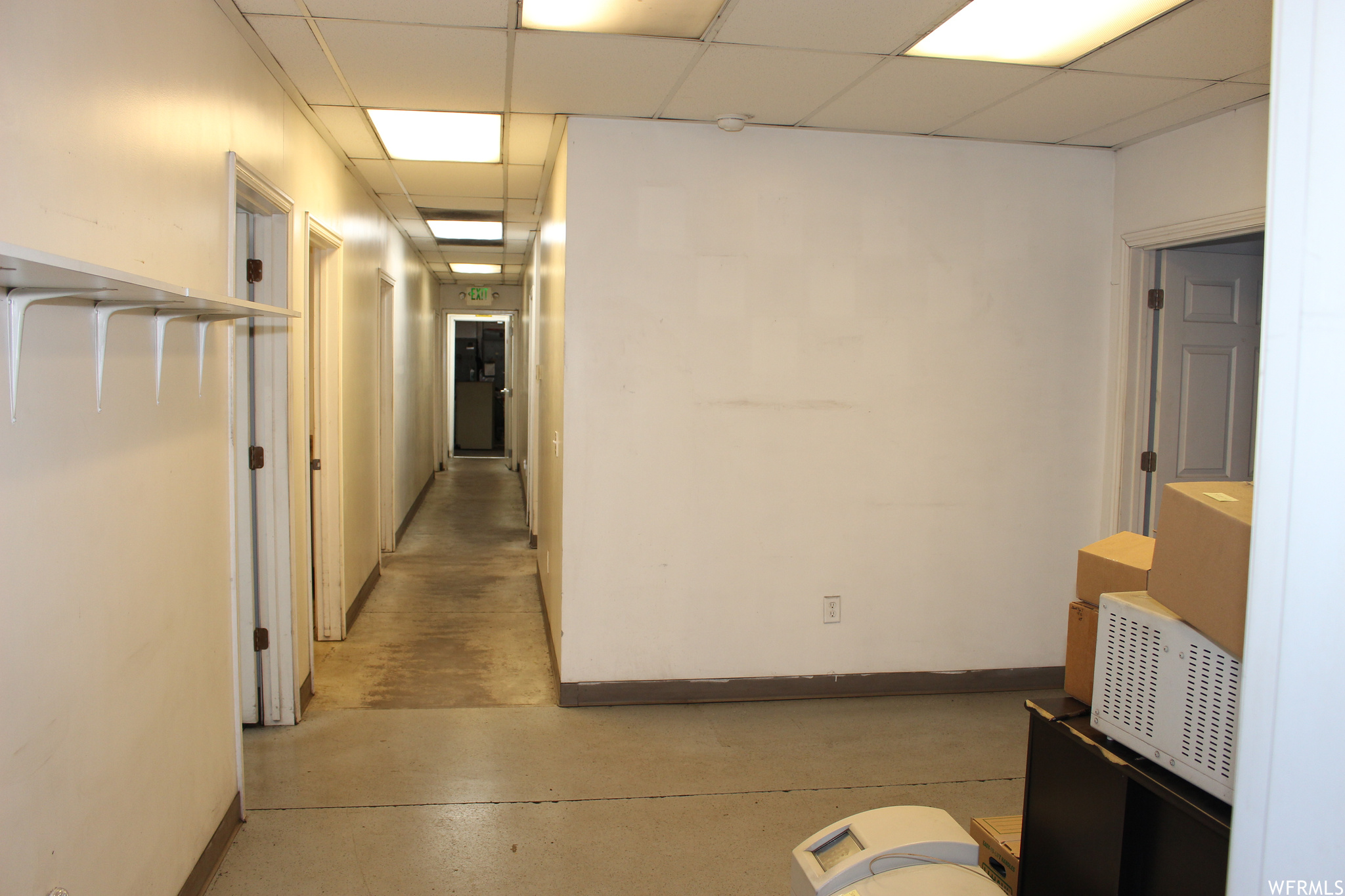 Corridor with a paneled ceiling