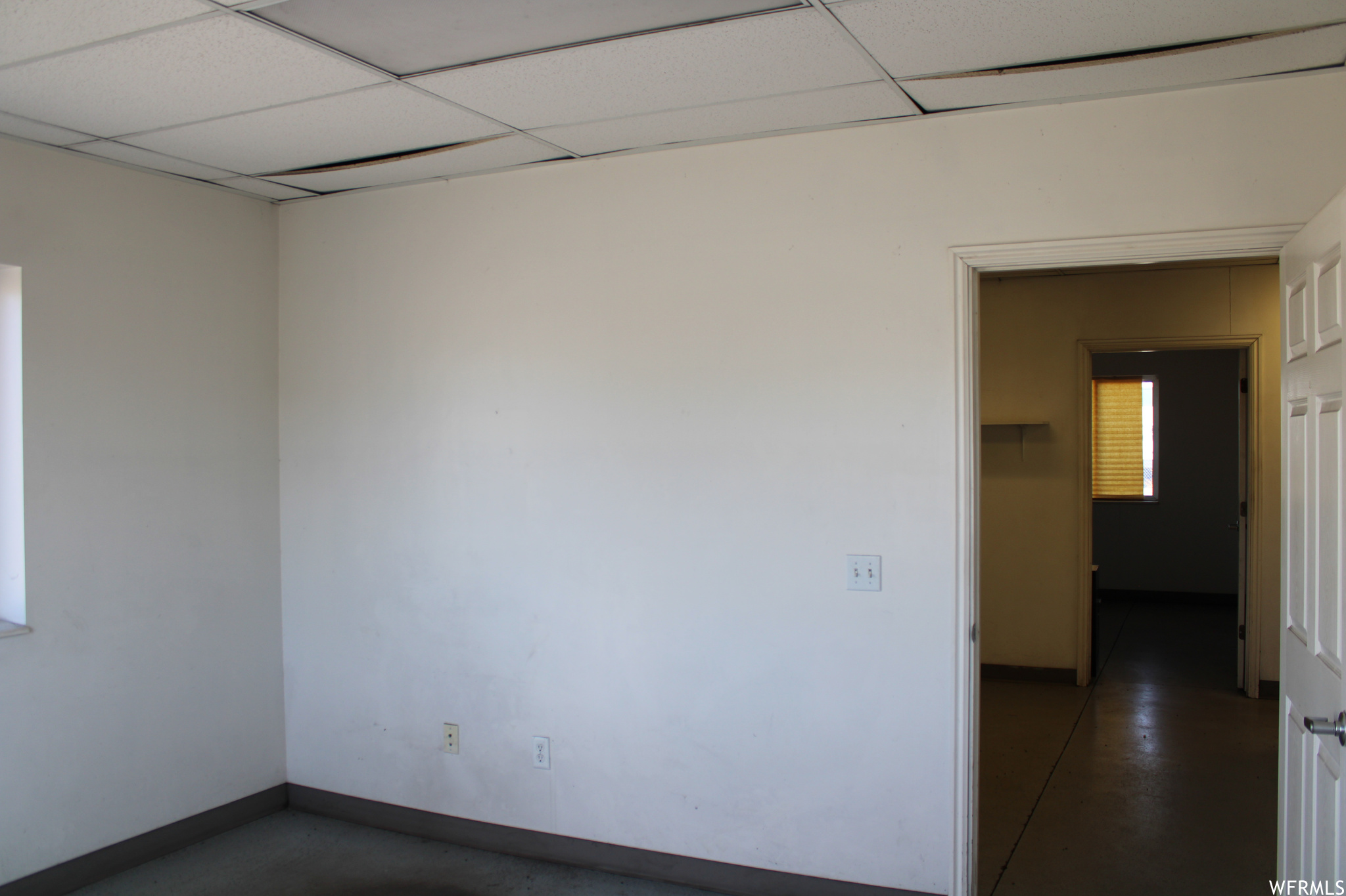 Empty room featuring a paneled ceiling