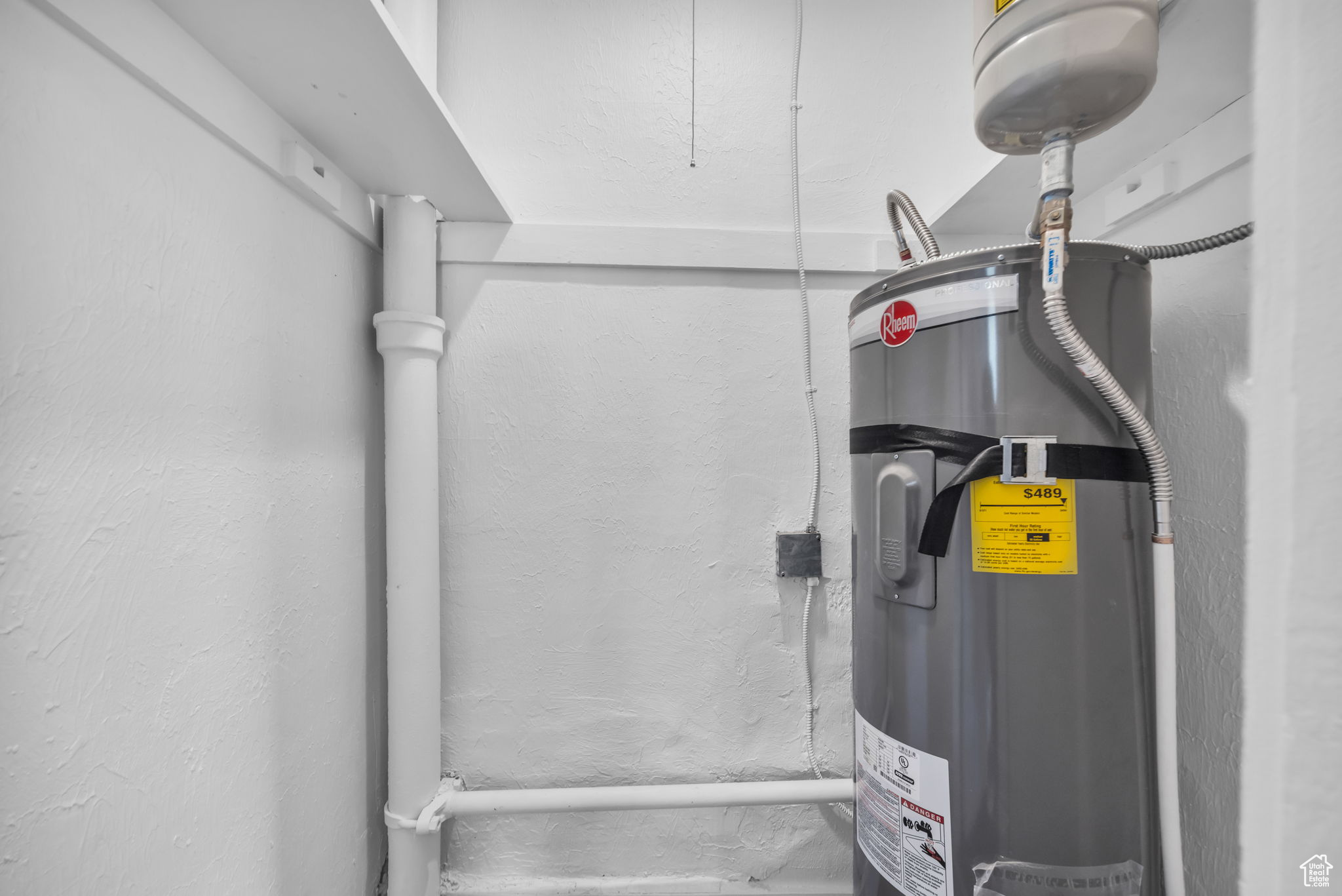 Utility room featuring electric water heater