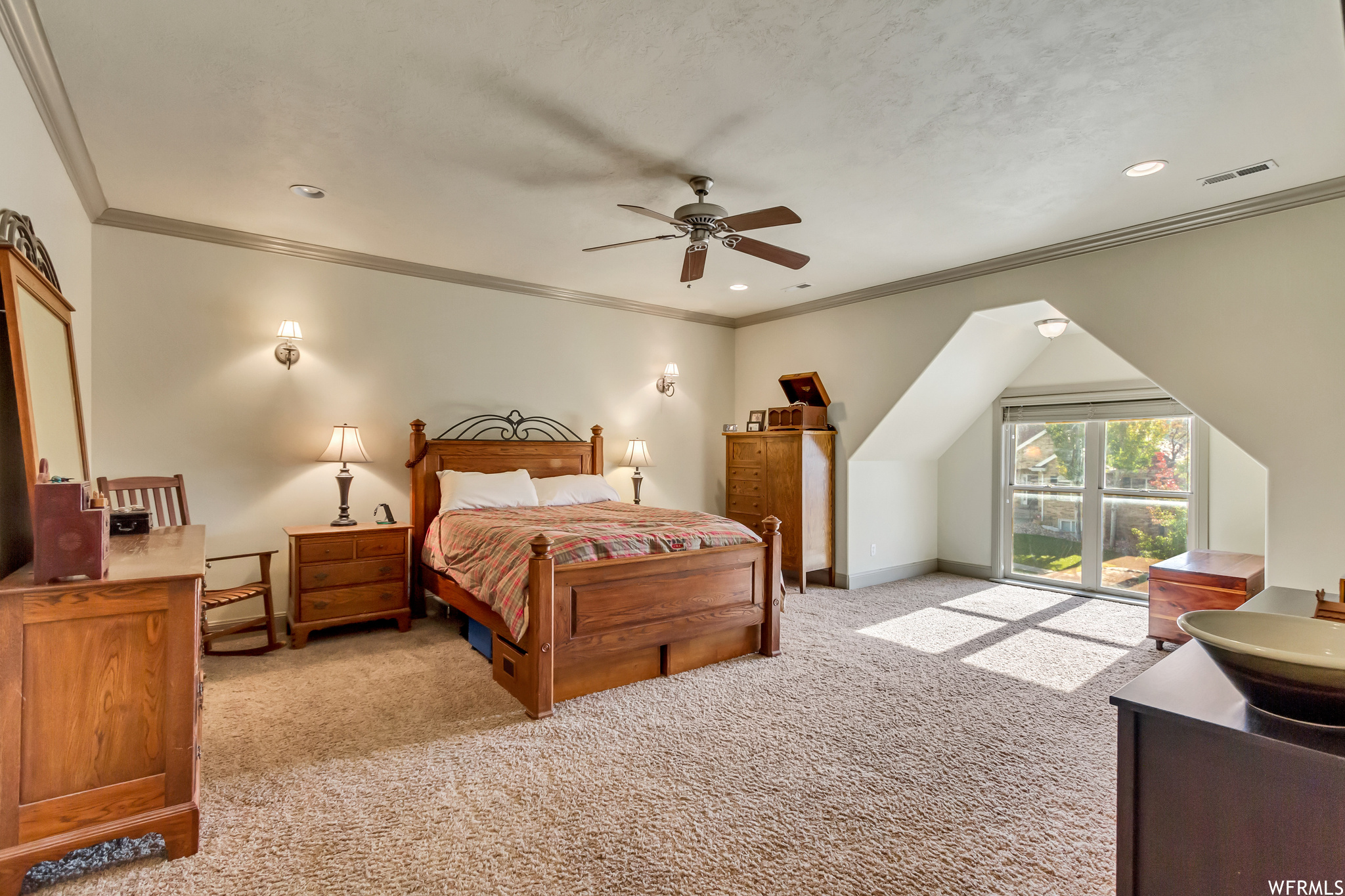 Bedroom featuring ceiling fan, ornamental molding, and light colored carpet