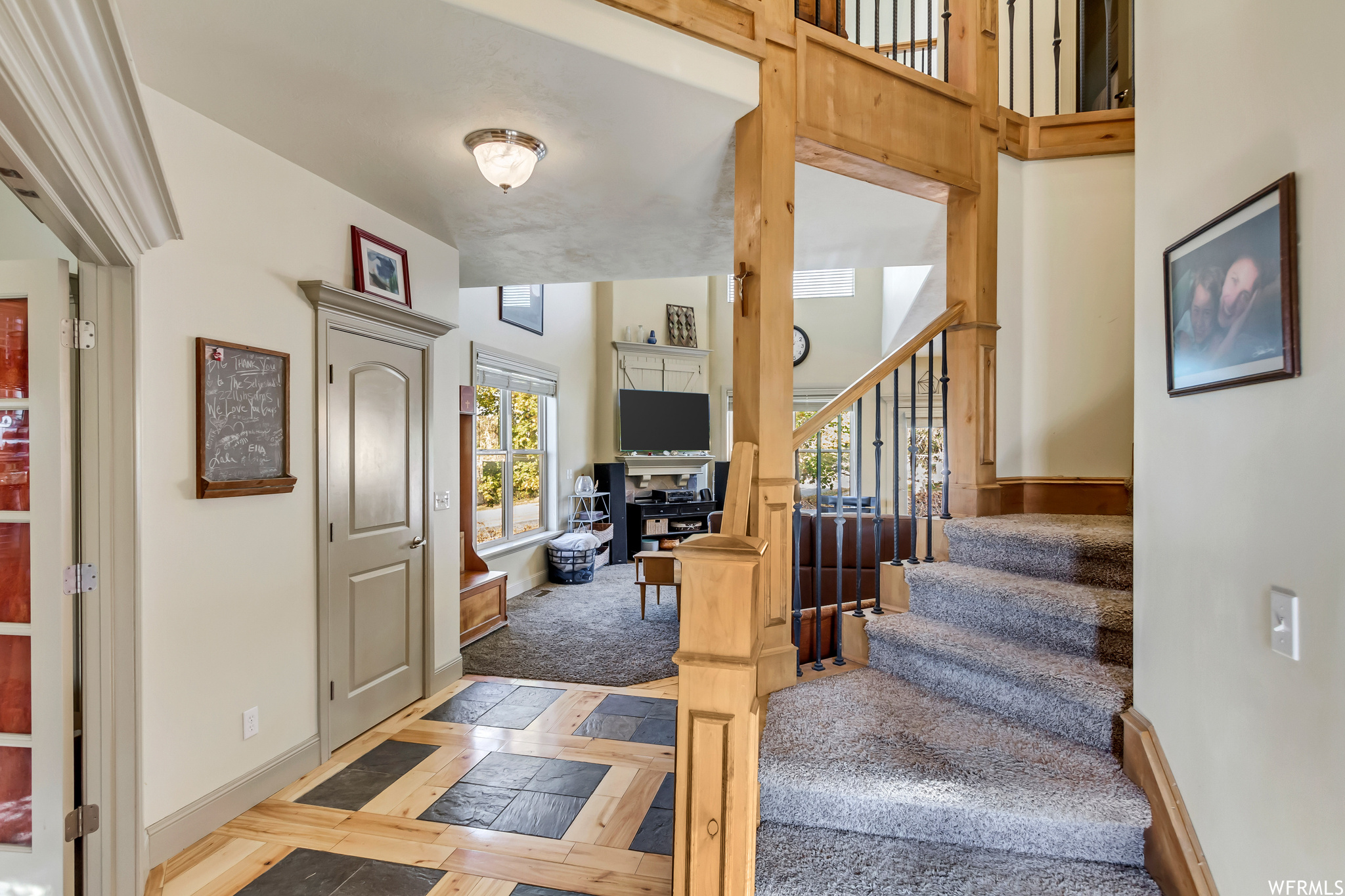 Entryway featuring a towering ceiling and custom floors