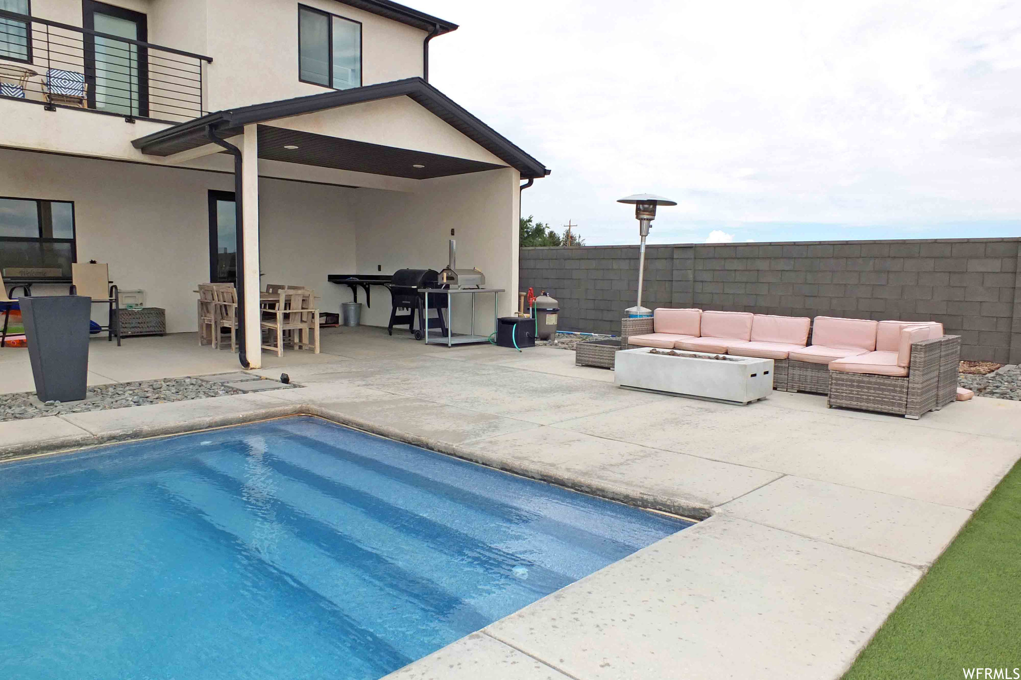 View of pool featuring a patio area, area for grilling, and outdoor lounge area