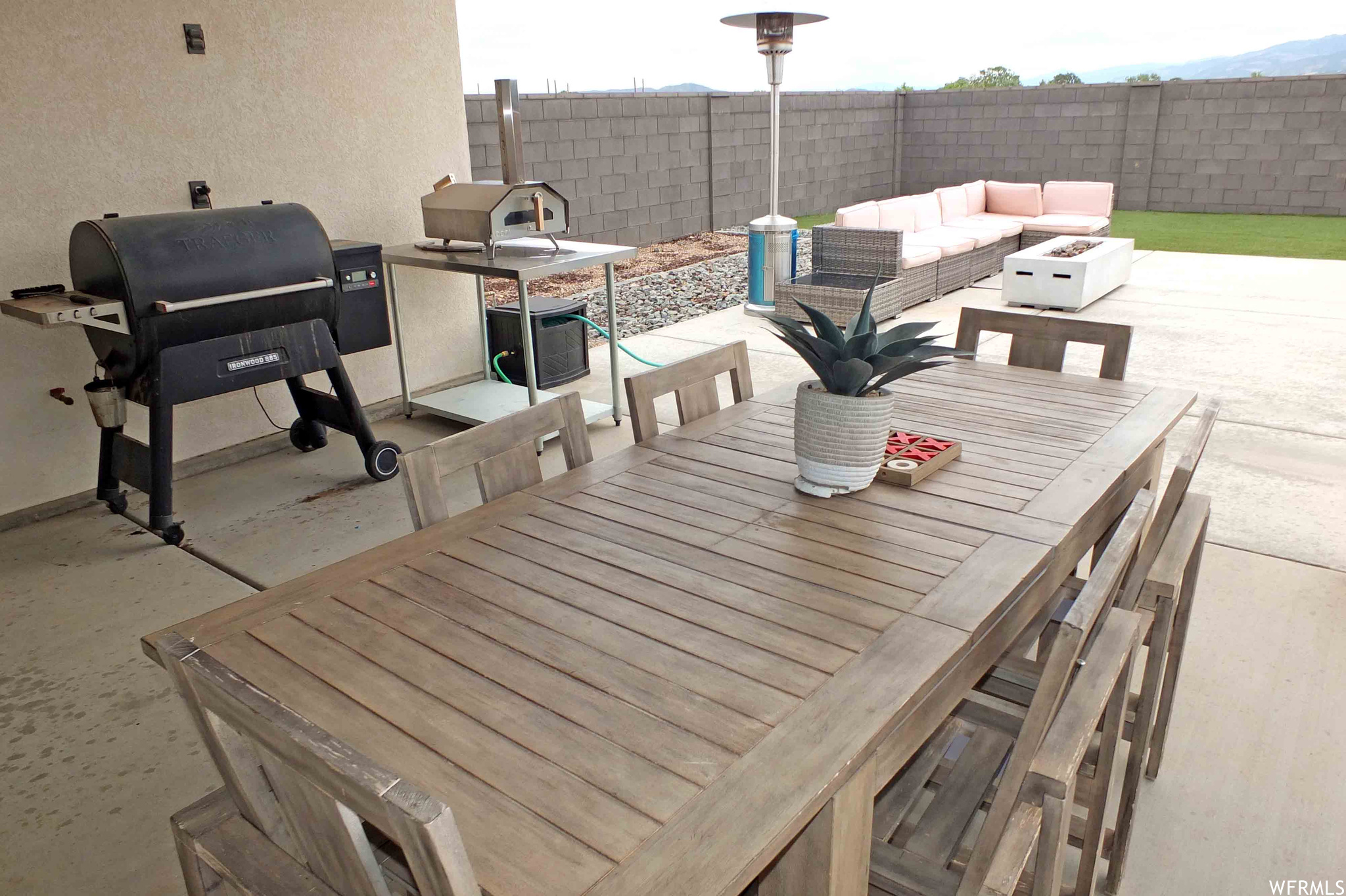 View of patio / terrace featuring a grill and an outdoor living space with a fire pit