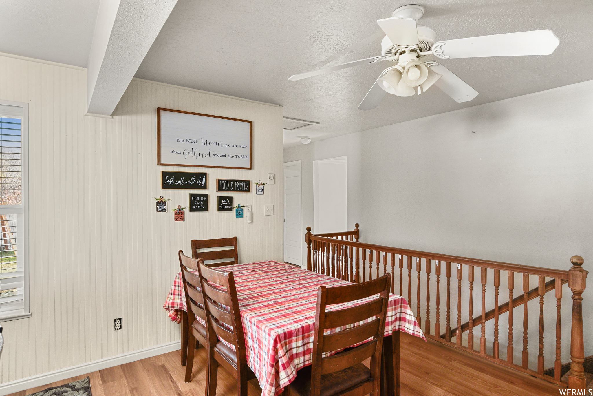 Dining room featuring ceiling fan and light hardwood / wood-style flooring