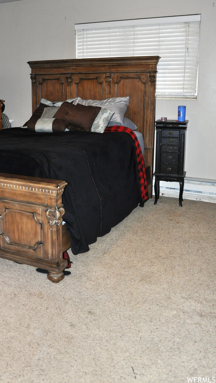 Bedroom featuring light colored carpet