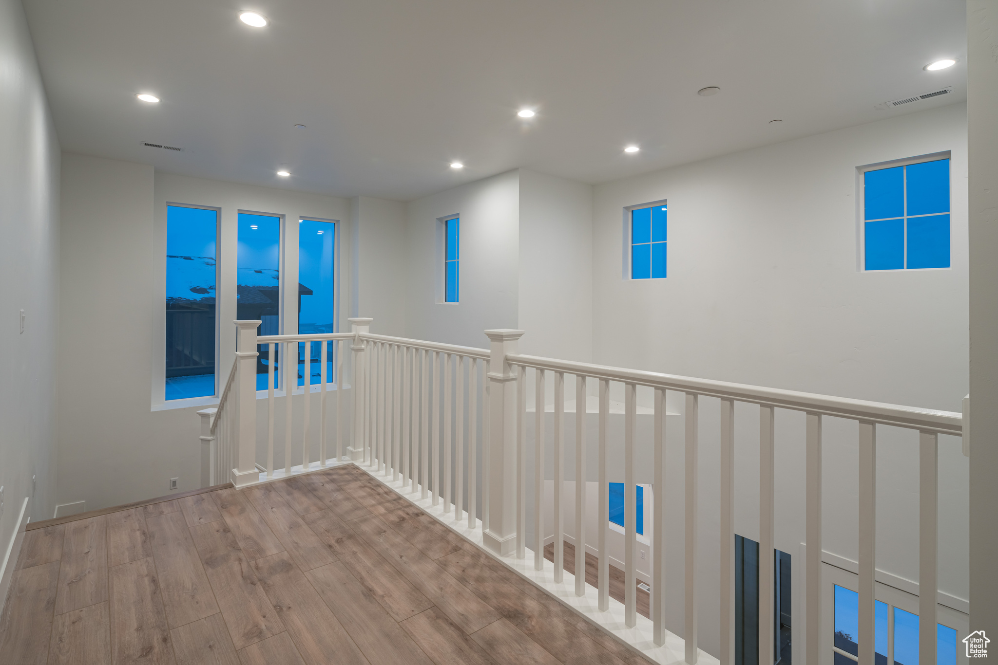 Hall with light hardwood / wood-style flooring